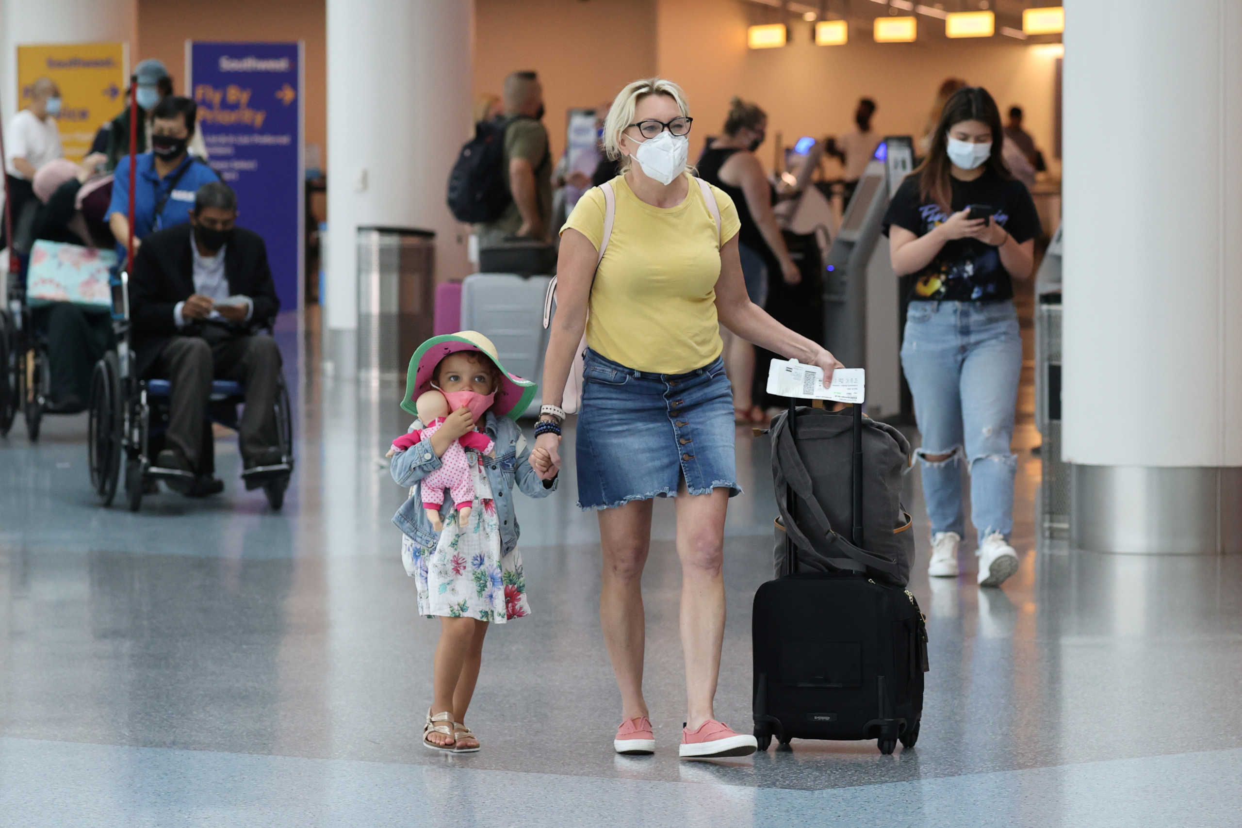 Passengers wear masks as they walk through LAX airport, as the global outbreak of the coronavirus disease (COVID-19) continues, in Los Angeles, California, U.S., August 4, 2020. REUTERS