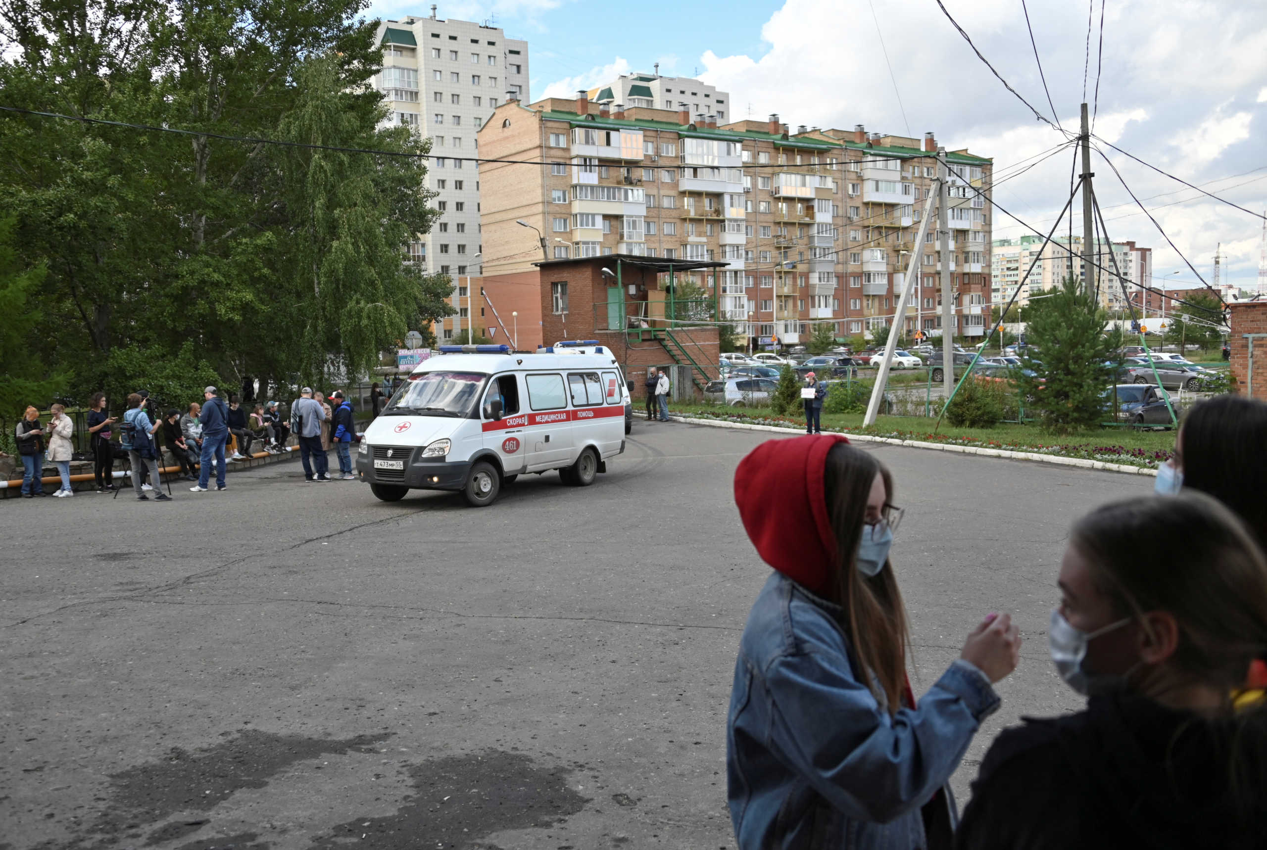 People gather outside a hospital, where Russian opposition leader Alexei Navalny receives medical treatment in Omsk, Russia August 21, 2020. Navalny was taken ill with suspected poisoning en route from Tomsk to Moscow on a plane, which made an emergency landing in Omsk. REUTERS