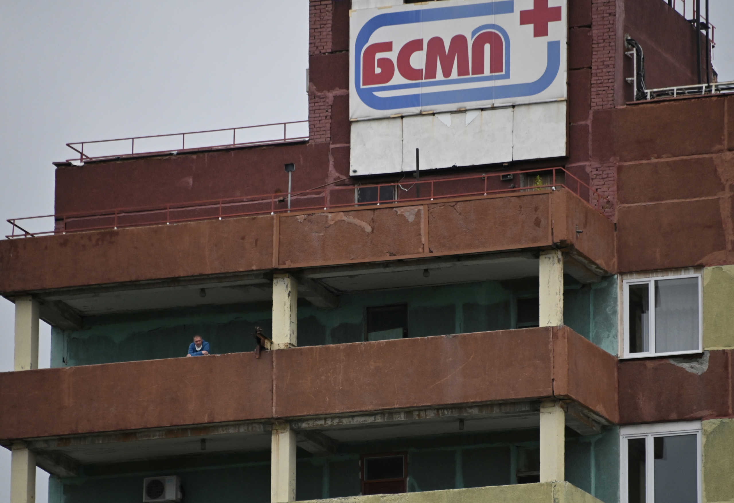 A man stands on a balcony of the City Clinical Emergency Hospital Number 1 where Russian opposition leader Alexei Navalny was admitted after suffering severe symptoms of what his spokeswoman called poisoning, in Omsk, Russia August 20, 2020. REUTERS