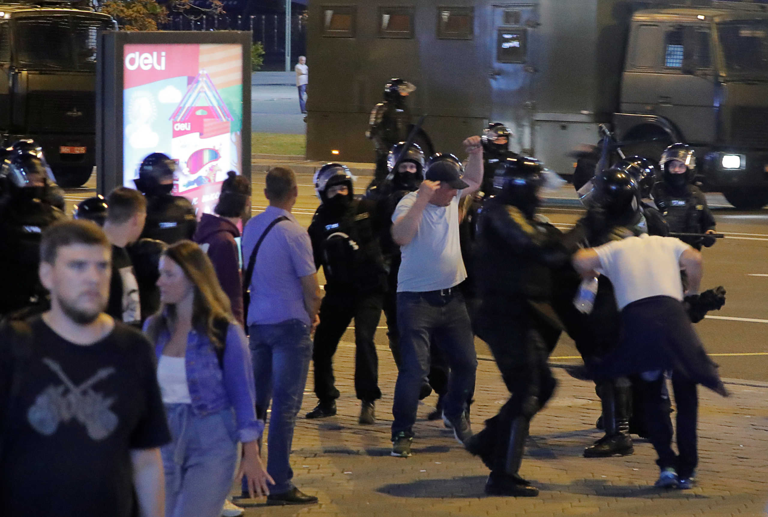 Belarusian law enforcement officers attempt to detain men during a rally of opposition supporters following the presidential election in Minsk, Belarus August 10, 2020. The opposition rejected official election results handing President Alexander Lukashenko a landslide re-election victory. REUTERS