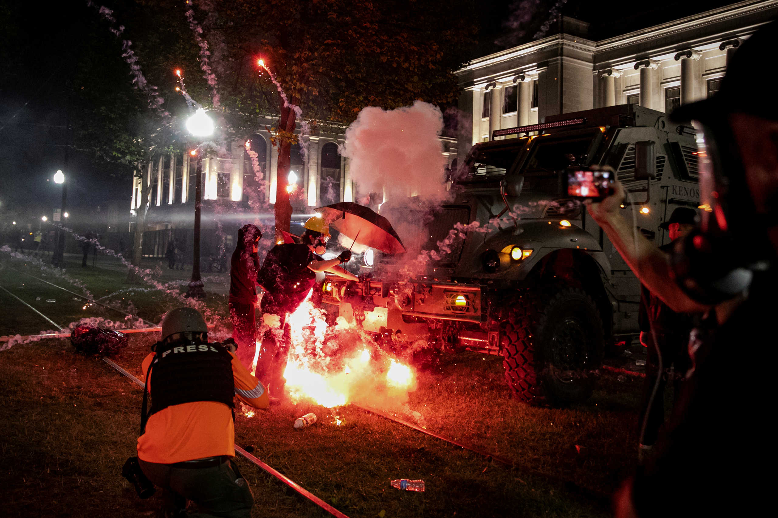 An incendiary device goes off in front of a Kenosha Country Sheriff Vehicle as demonstrators take part in a protest following the police shooting of Jacob Blake, a Black man, in Kenosha, Wisconsin, U.S. August 25, 2020. REUTERS