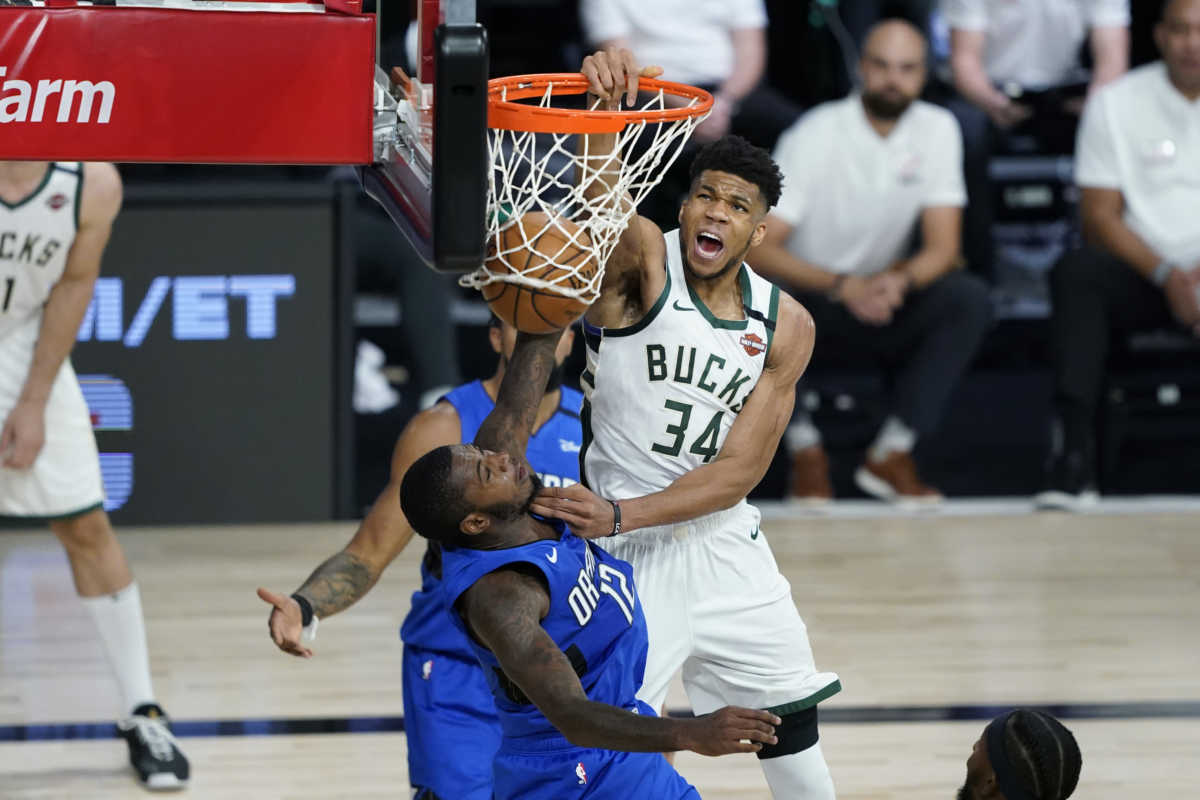 Aug 20, 2020; Lake Buena Vista, Florida, USA; Milwaukee Bucks forward Giannis Antetokounmpo (34) scores over Orlando Magic forward Gary Clark (12) during the second half in game two of the first round of the 2020 NBA Playoffs at The Field House. Mandatory Credit: Ashley Landis