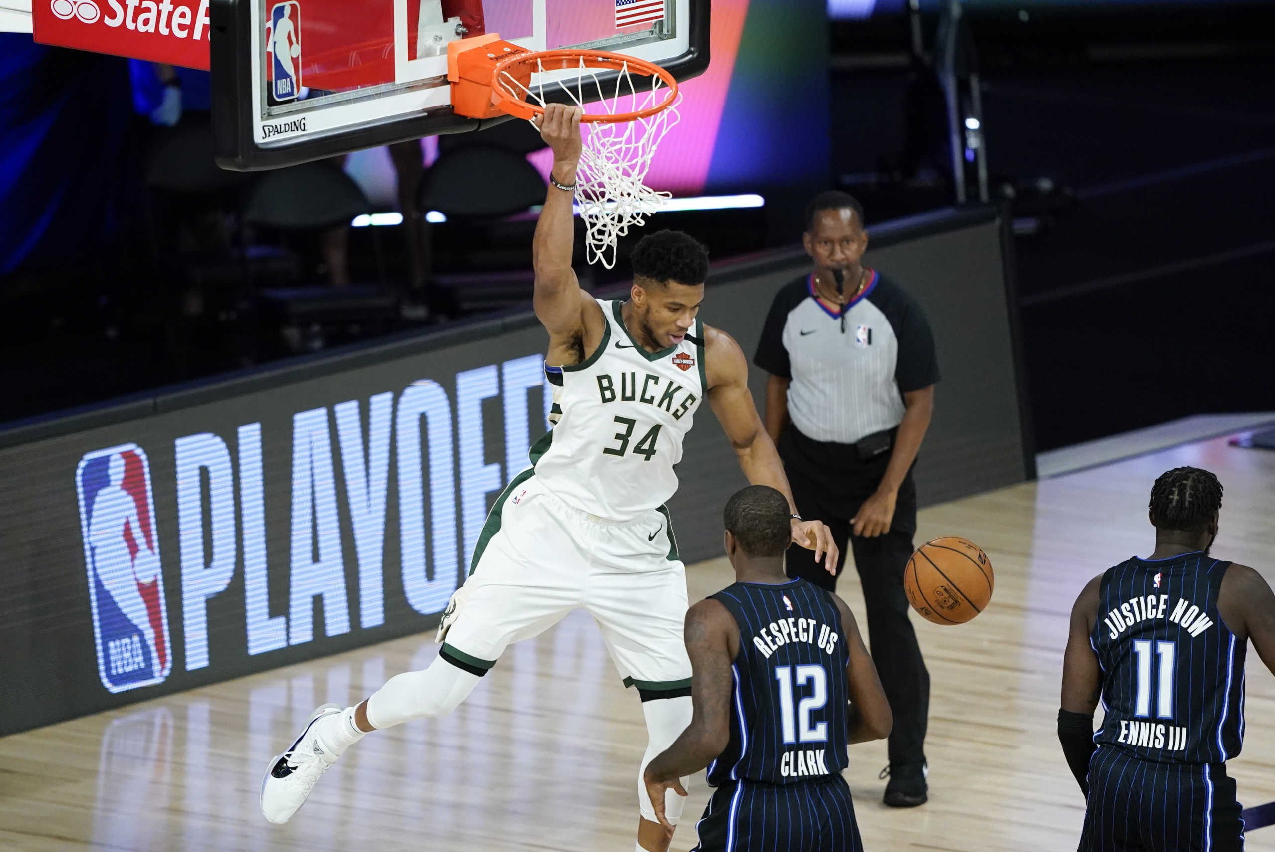Aug 24, 2020; Lake Buena Vista, Florida, USA; Milwaukee Bucks' Giannis Antetokounmpo (34) dunks the ball over Orlando Magic's Gary Clark (12) during the first half in game four of the first round of the 2020 NBA Playoffs at The Field House. Mandatory Credit: Ashley Landis

 Monday, Aug. 24, 2020, in Lake Buena Vista, Fla. (AP Photo