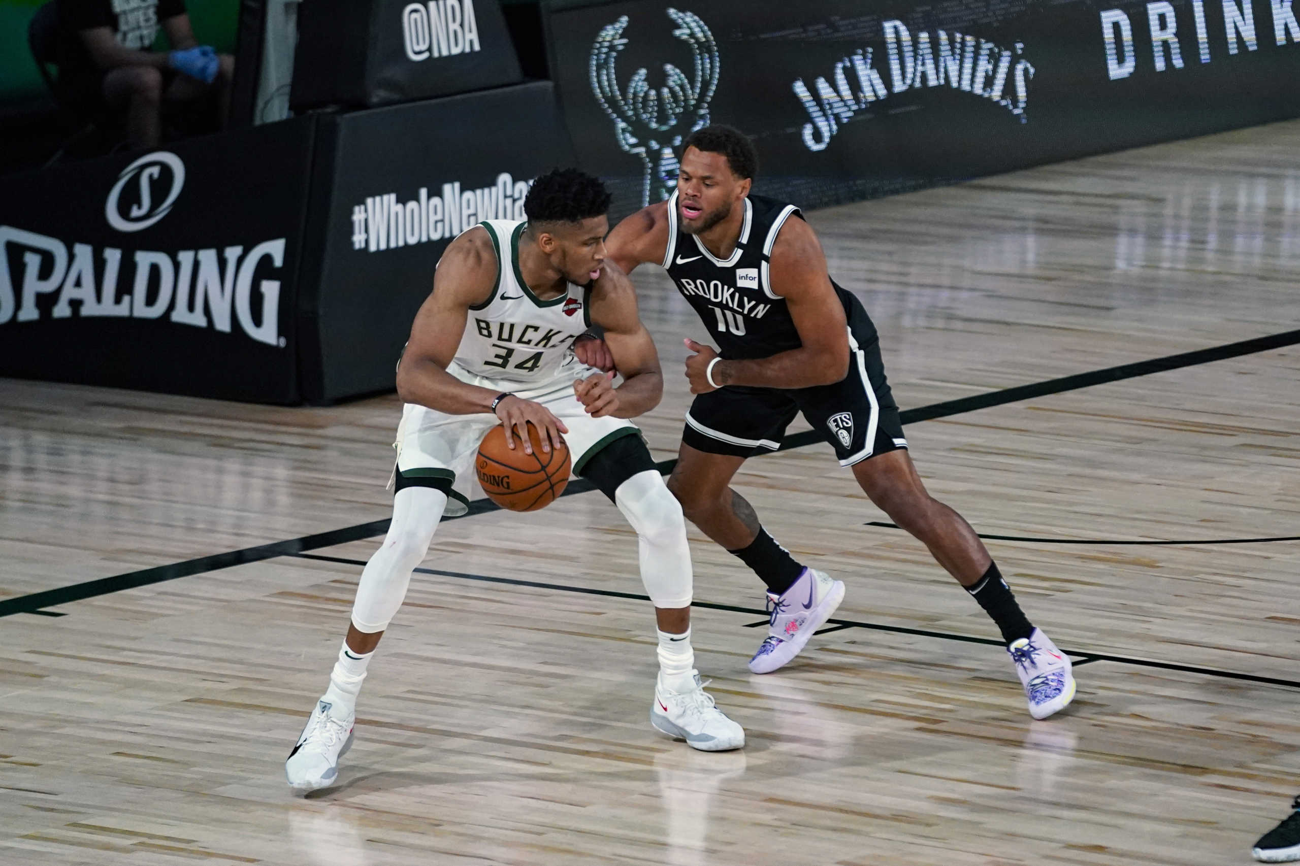 Aug 4, 2020; Lake Buena Vista, USA;  Brooklyn Nets guard Justin Anderson (10) defends Milwaukee Bucks forward Giannis Antetokounmpo (34) during the first half of an NBA basketball game Tuesday, Aug. 4, 2020 in Lake Buena Vista, Fla. Mandatory Credit: Ashley Landis