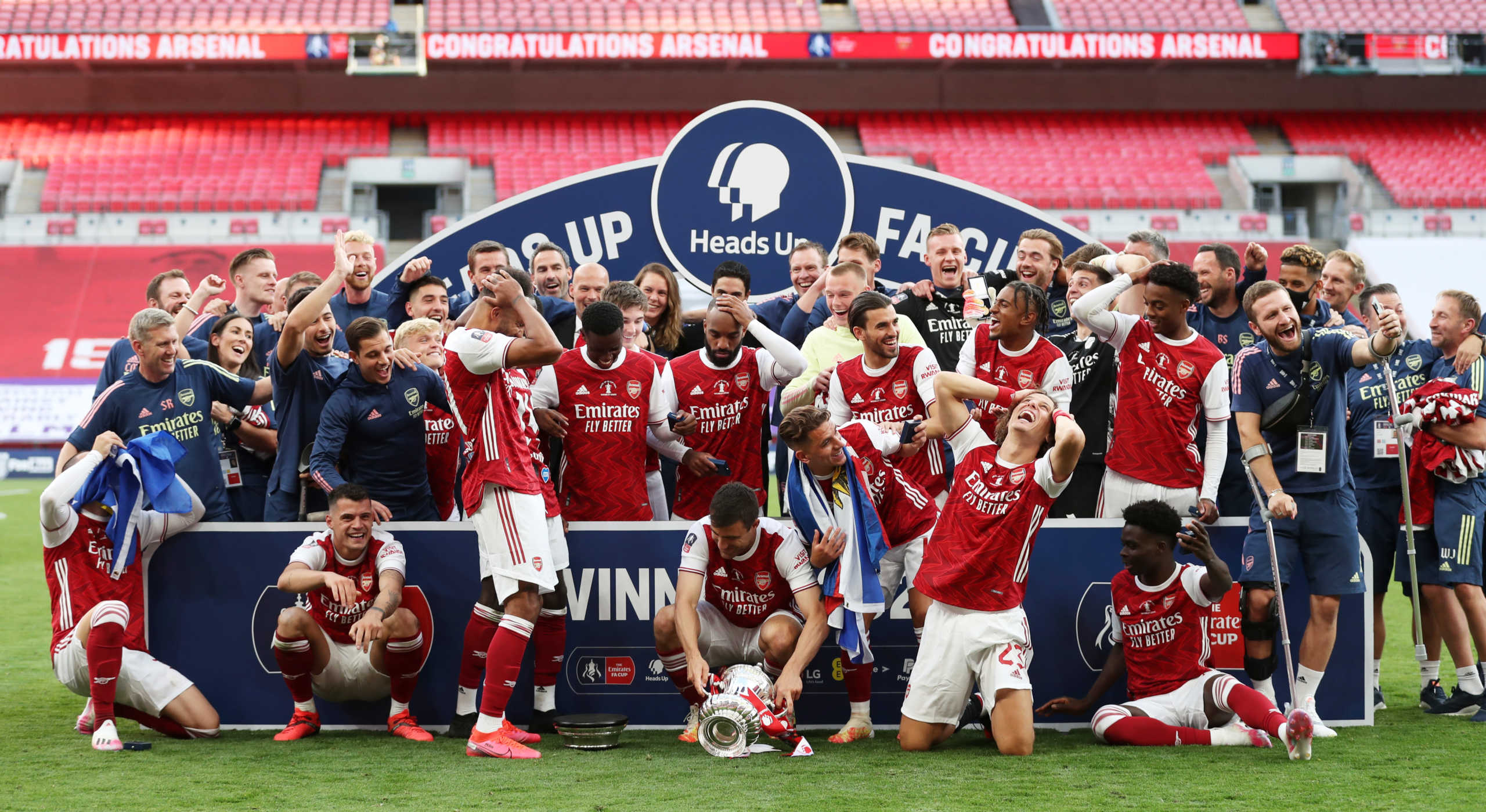 Soccer Football - FA Cup Final - Arsenal v Chelsea - Wembley Stadium, London, Britain - August 1, 2020 Arsenal's Pierre-Emerick Aubameyang reacts after dropping the trophy after winning the FA Cup, as play resumes behind closed doors following the outbreak of the coronavirus disease (COVID-19) Pool via REUTERS