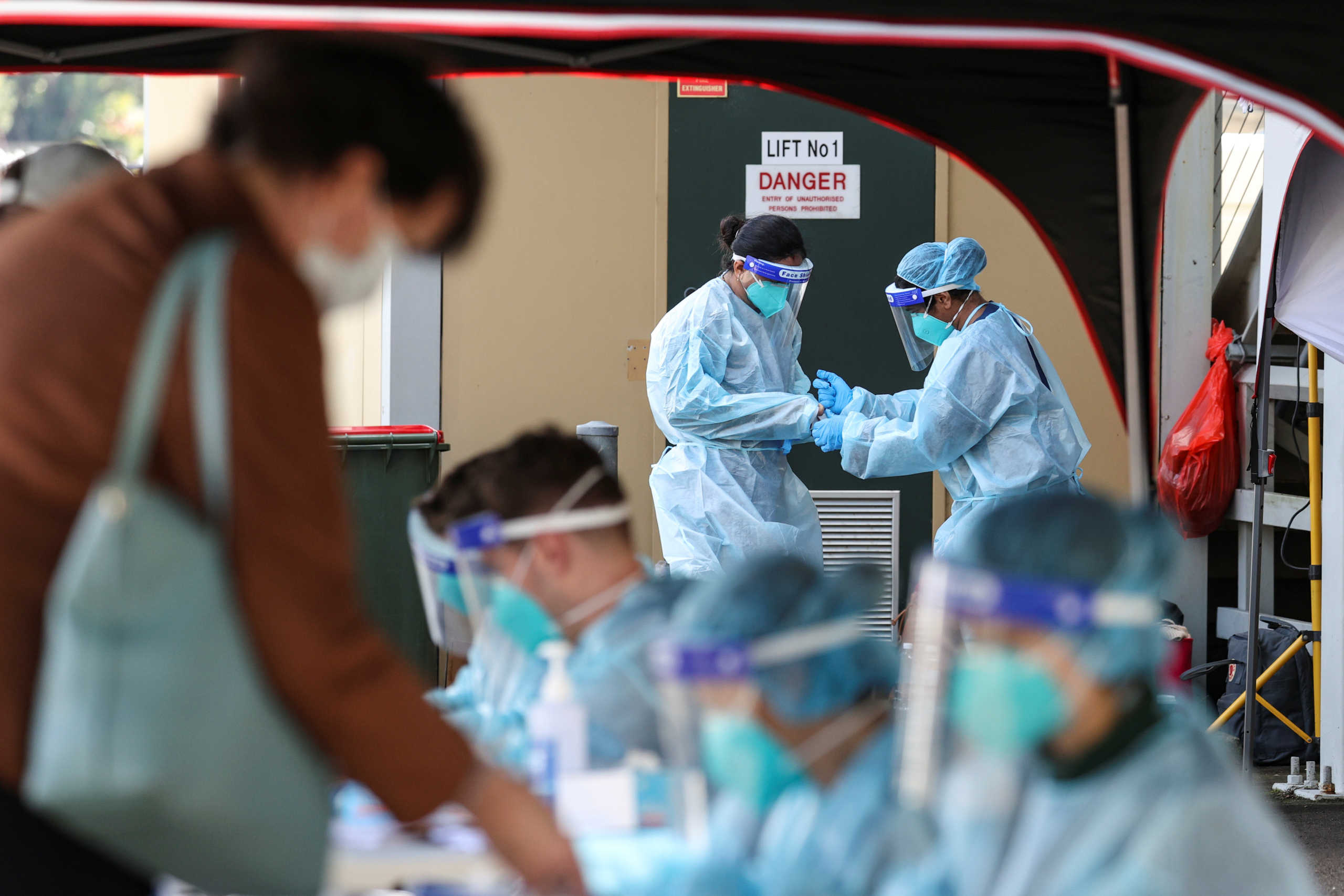Medical personnel in personal protective equipment (PPE) are seen at a pop-up testing centre for the coronavirus disease (COVID-19), as the state of New South Wales grapples with an outbreak of new cases, in Sydney, Australia, July 30, 2020. REUTERS