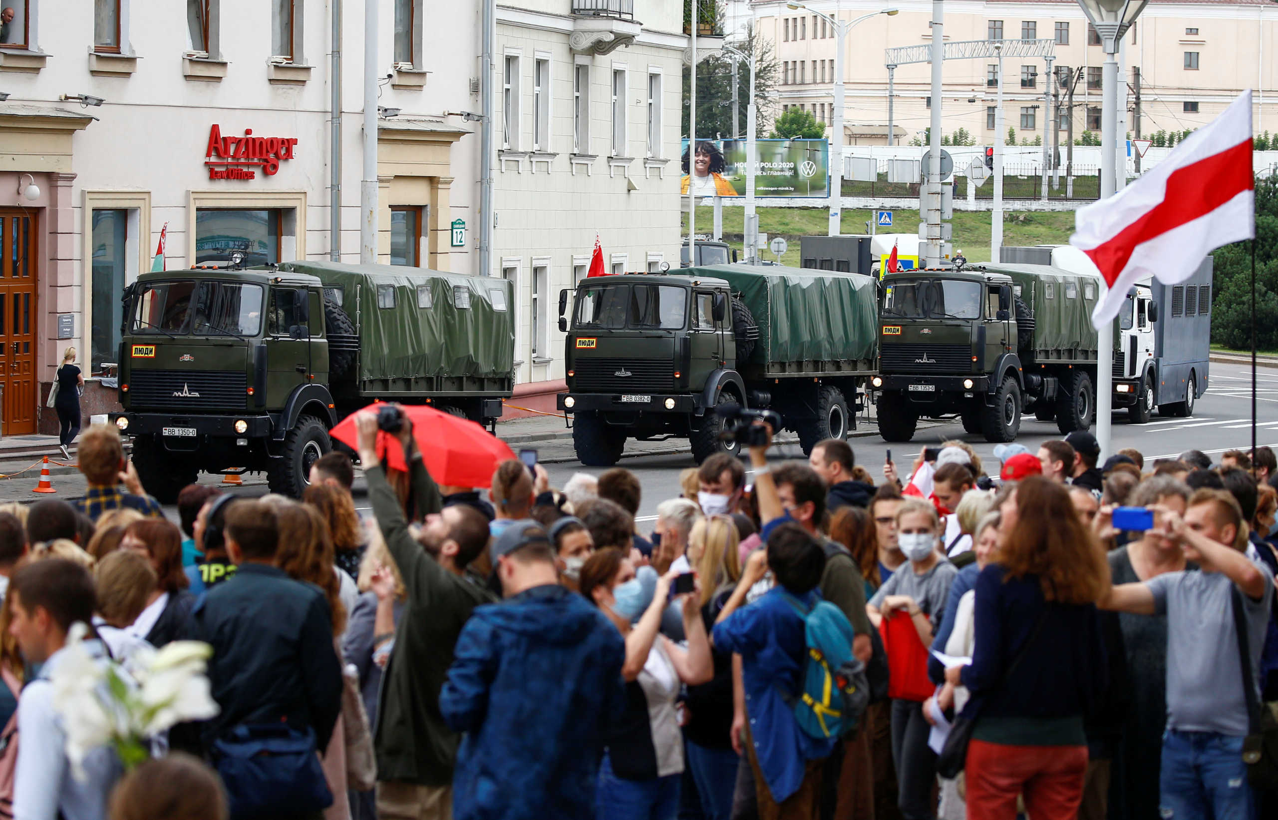 Law enforcement vehicles are seen as people take part in a rally against presidential election results near the Ministry of Education in Minsk, Belarus August 25, 2020. REUTERS