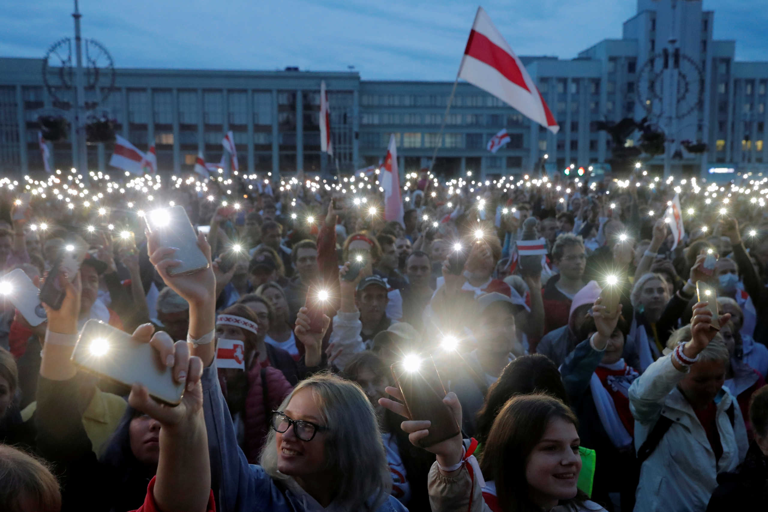 FILE PHOTO: People flash lights from their phones during an opposition demonstration to protest against presidential election results at the Independence Square in Minsk, Belarus, August 25, 2020. REUTERS