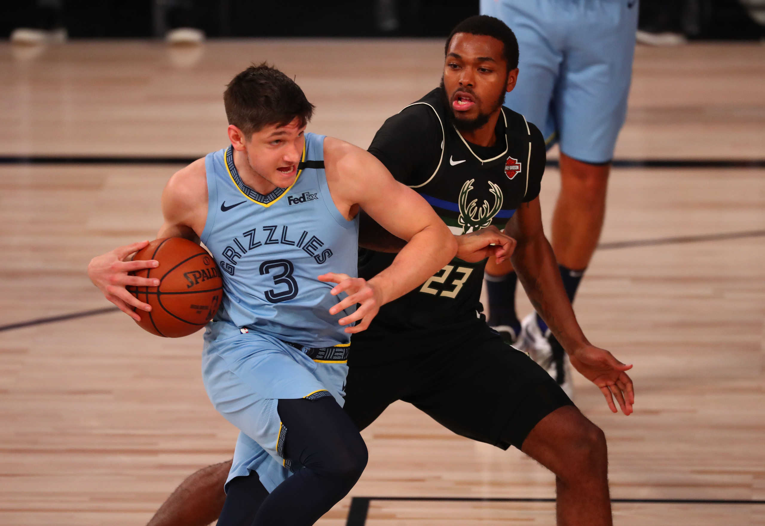 Aug 13, 2020; Lake Buena Vista, Florida, USA;  Memphis Grizzlies guard Grayson Allen (3) drives against Milwaukee Bucks guard Sterling Brown (23) in the first half during an NBA basketball game at ESPN Wide World of Sports Complex. Mandatory Credit: Kim Klement-USA TODAY Sports