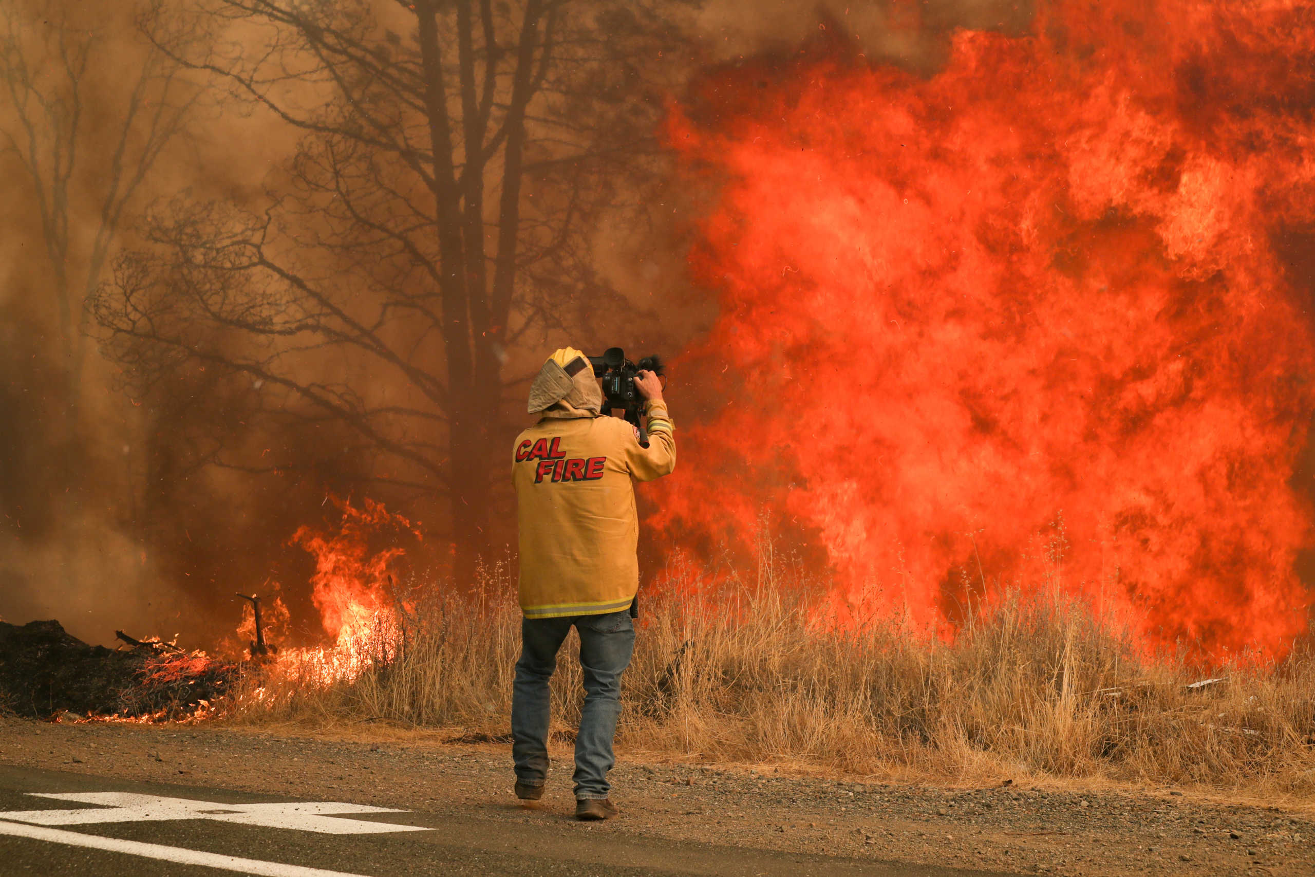 NBC News cameraman Tim Walton covers the LNU Lightning Complex Fire as it engulfs trees and brush in Lake County, California, U.S. August 23, 2020. REUTERS