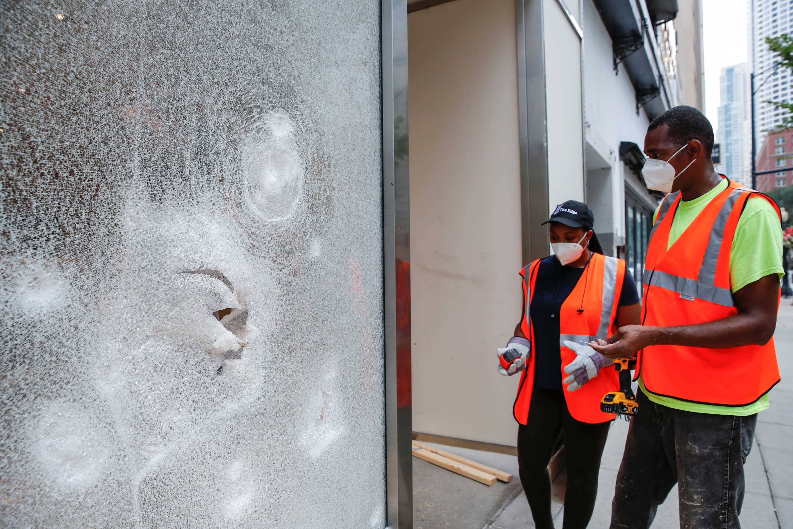 Workers clean up a looted shop in Chicago, Illinois, U.S. August 10, 2020.  REUTERS