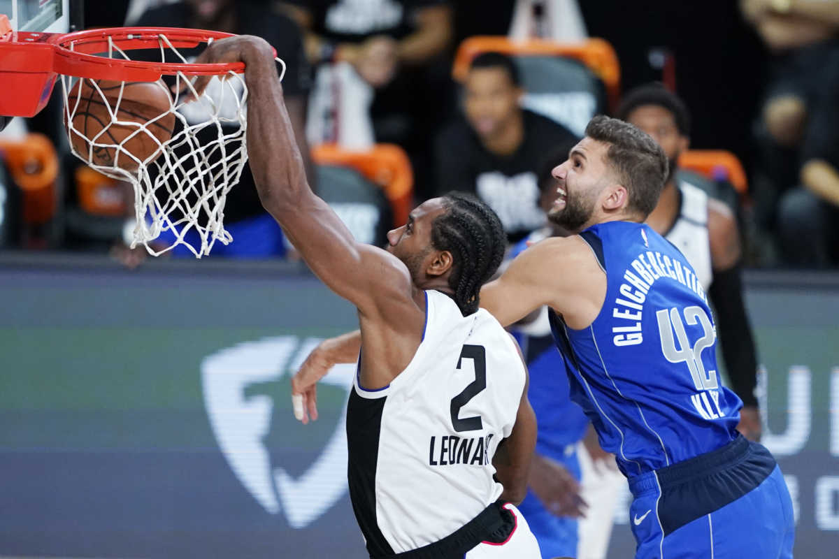 Aug 21, 2020; Lake Buena Vista, Florida, USA; Los Angeles Clippers' Kawhi Leonard (2) scores ahead of Dallas Mavericks' Maxi Kleber (42) during the second half in a NBA basketball first round playoff game at AdventHealth Arena. Mandatory Credit: Ashley Landis