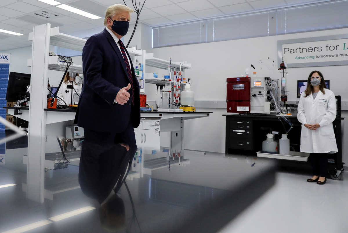 FILE PHOTO: U.S. President Donald Trump gestures during a tour of the Fujifilm Diosynth Biotechnologies' Innovation Center, a pharmaceutical manufacturing plant where components for a potential coronavirus disease  (COVID-19) vaccine candidate are being developed, in Morrrisville, North Carolina, U.S., July 27, 2020. REUTERS