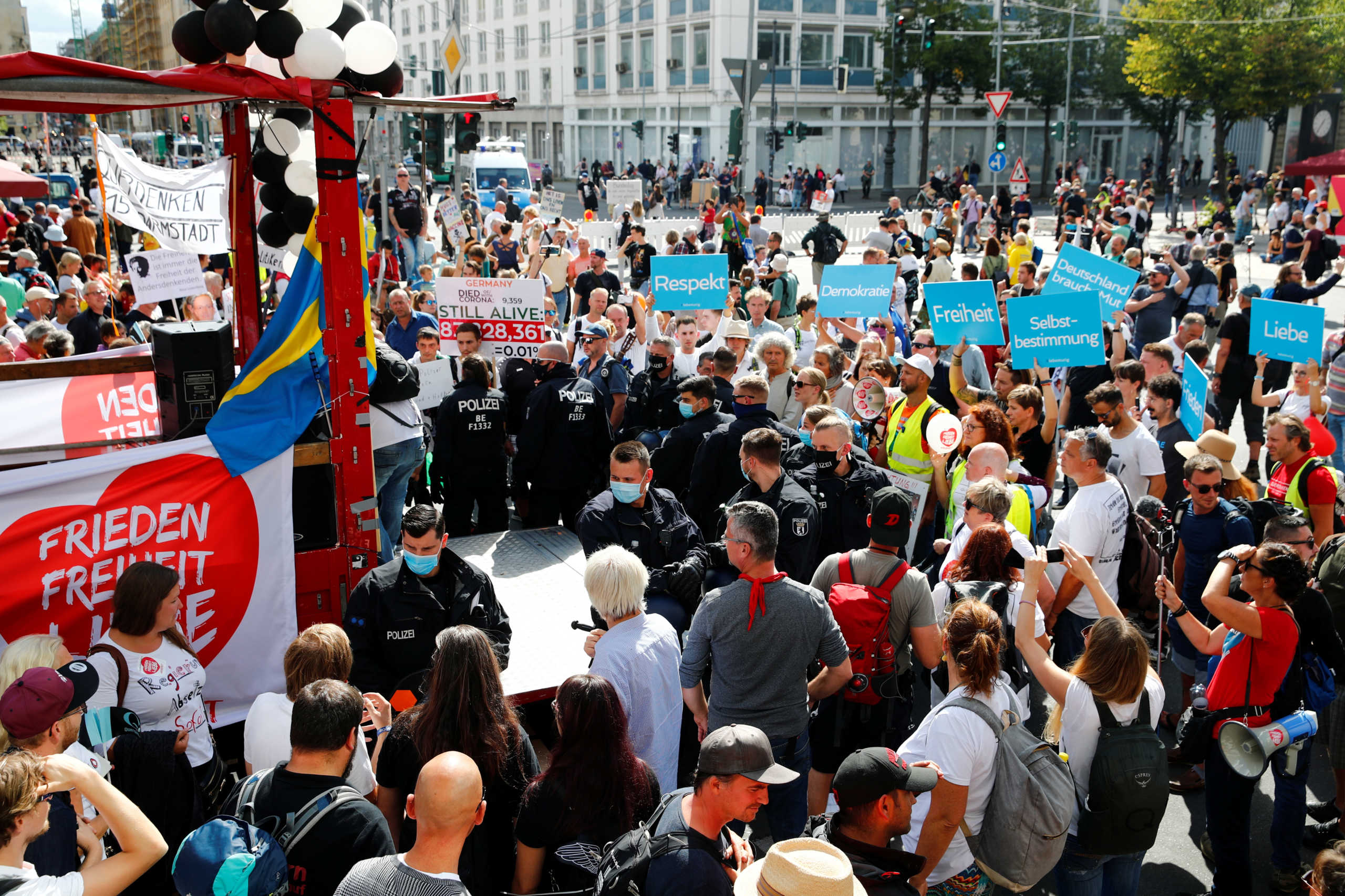 Police officers stand guard next to demonstrators during a rally against the government's restrictions following the coronavirus disease (COVID-19) outbreak, in Berlin, Germany August 29, 2020. REUTERS