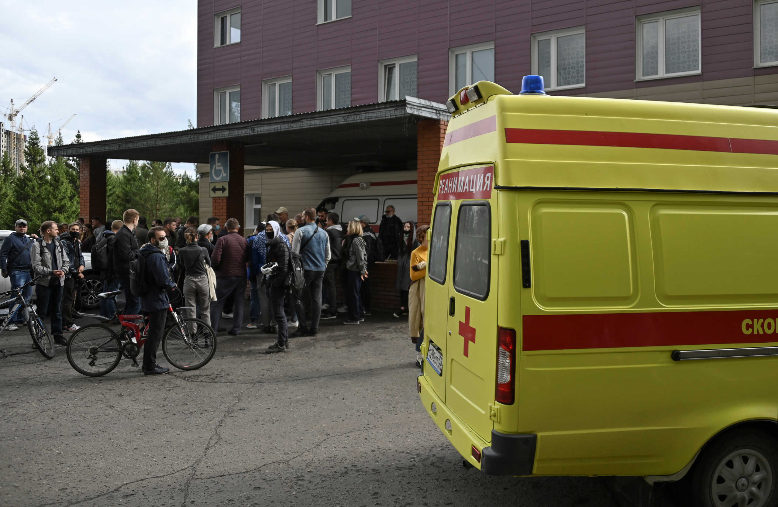 People gather outside a hospital, where Russian opposition leader Alexei Navalny receives medical treatment in Omsk, Russia August 21, 2020. Navalny was taken ill with suspected poisoning en route from Tomsk to Moscow on a plane, which made an emergency landing in Omsk. REUTERS