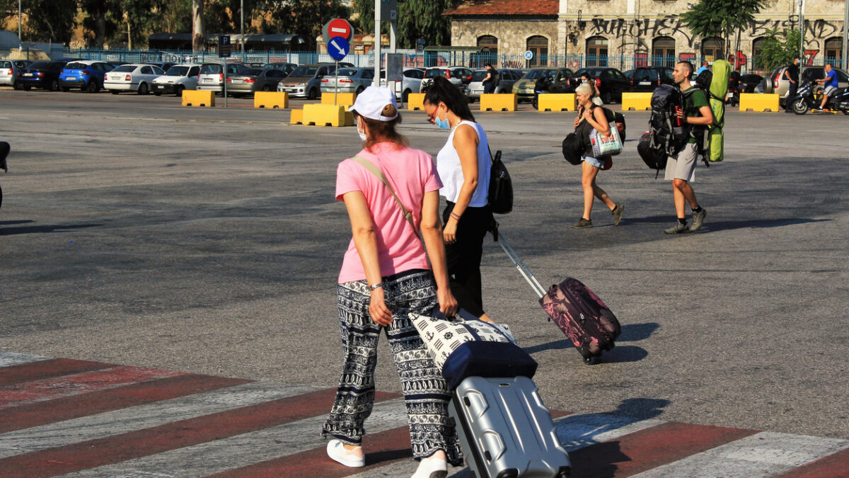 Passengers embarking on a ferry boat at the port of Piraeus, with Greek islands as destination