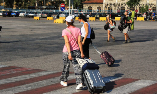 Passengers embarking on a ferry boat at the port of Piraeus, with Greek islands as destination