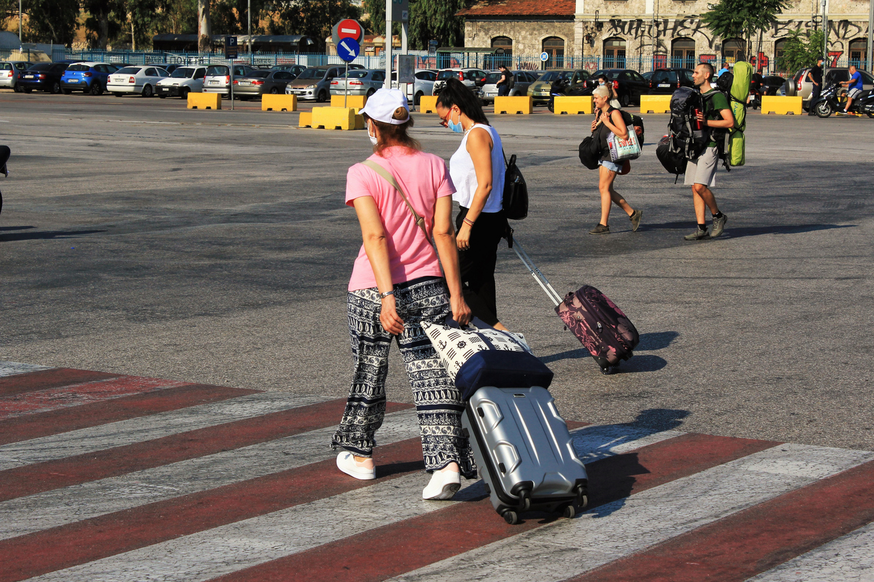 Passengers embarking on a ferry boat at the port of Piraeus, with Greek islands as destination