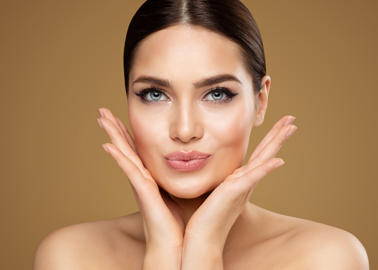 Beauty Model showing Cheekbones and Full Lips. Beautiful Woman Face Skin Care. Women Dermal Filler and Permanent Make up Cosmetology. Lip Augmentation Facial Lifting Spa Massage over Beige Background