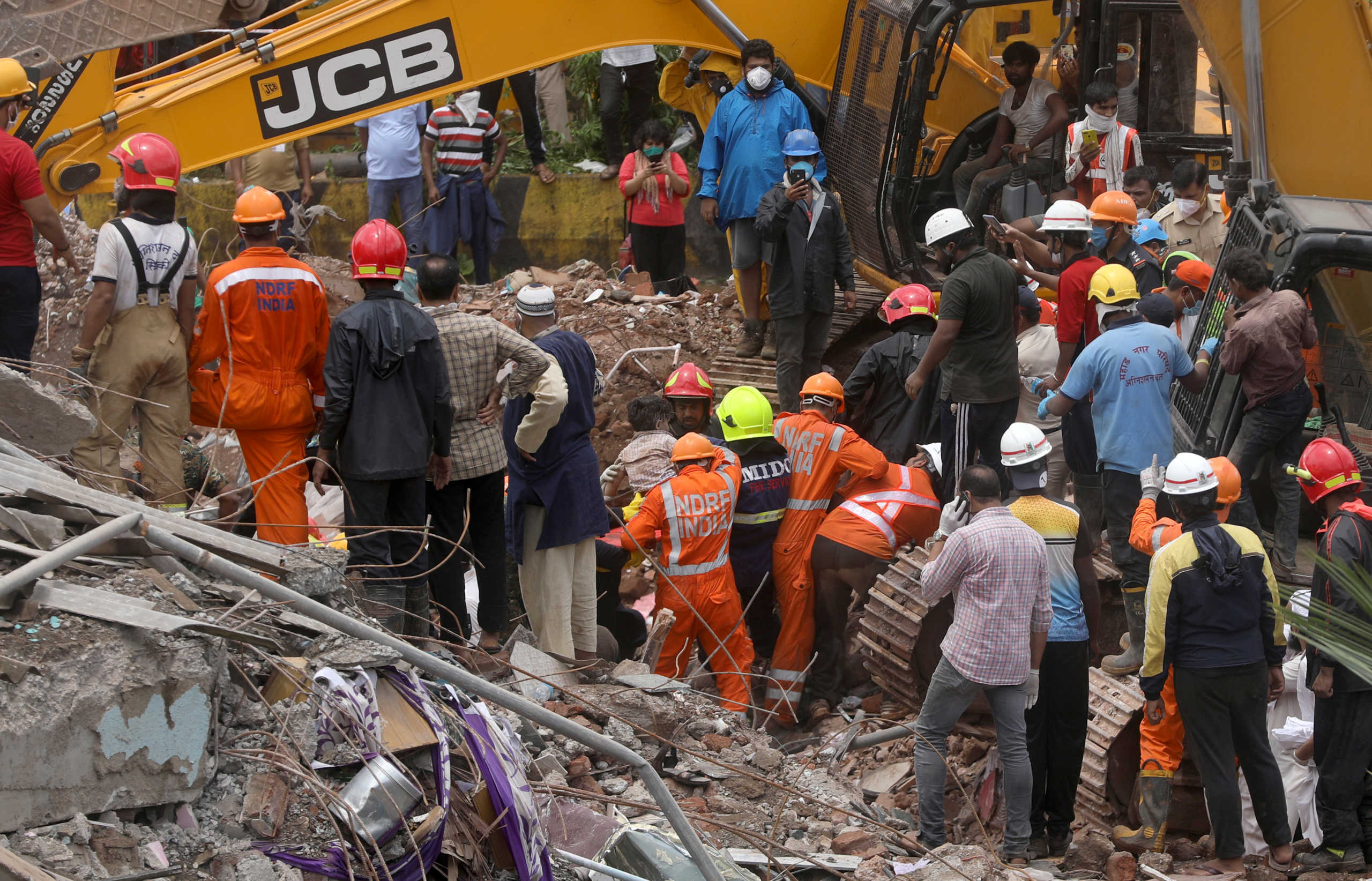 Rescue workers carry Mohammed Bangi, a four-year-old boy, after he was rescued from the rubble at the site of a collapsed five-storey building in Mahad in Raigad district in the western state of Maharashtra, India, August 25, 2020. REUTERS