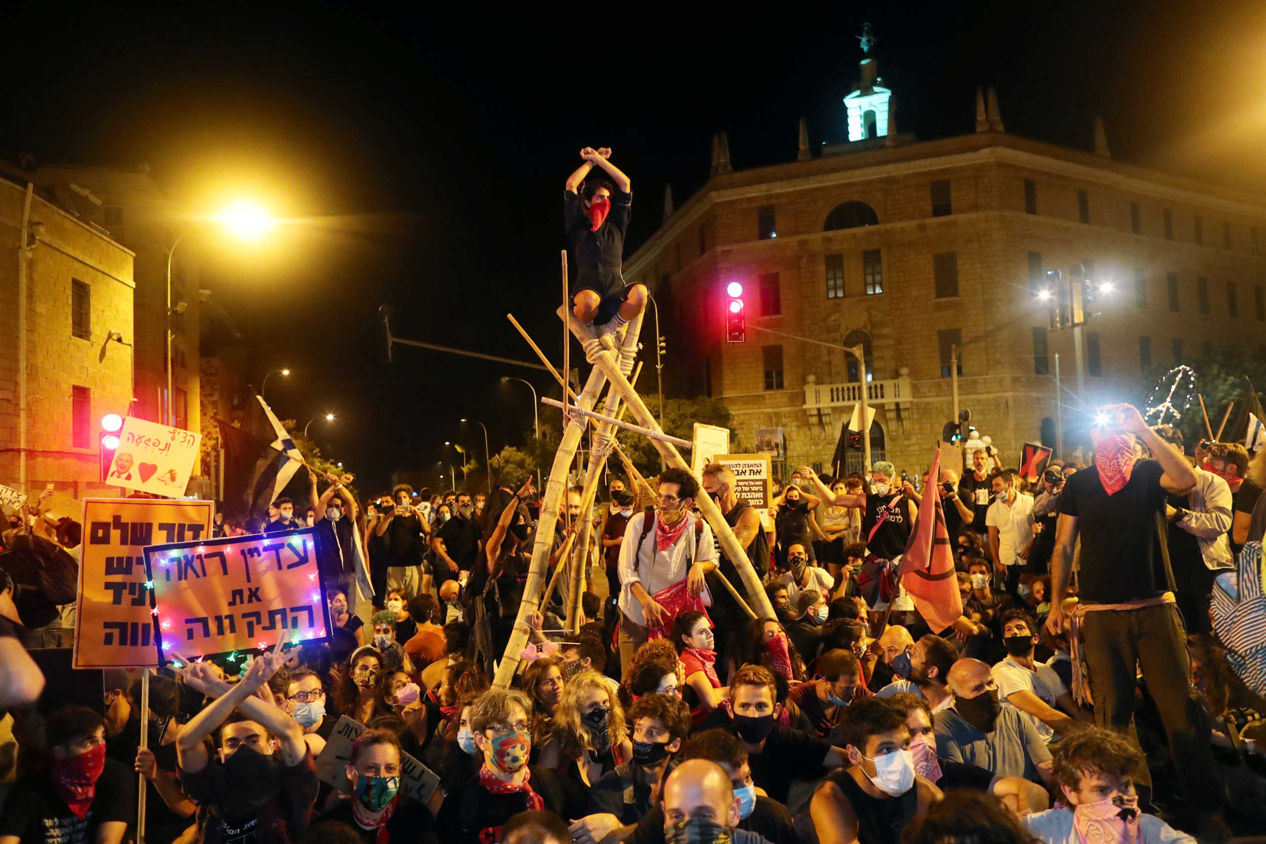 People protest against Israeli Prime Minister Benjamin Netanyahu's alleged corruption and economic hardship stemming from lockdown during the coronavirus disease (COVID-19) crisis, near his residence in Jerusalem August 22, 2020. REUTERS