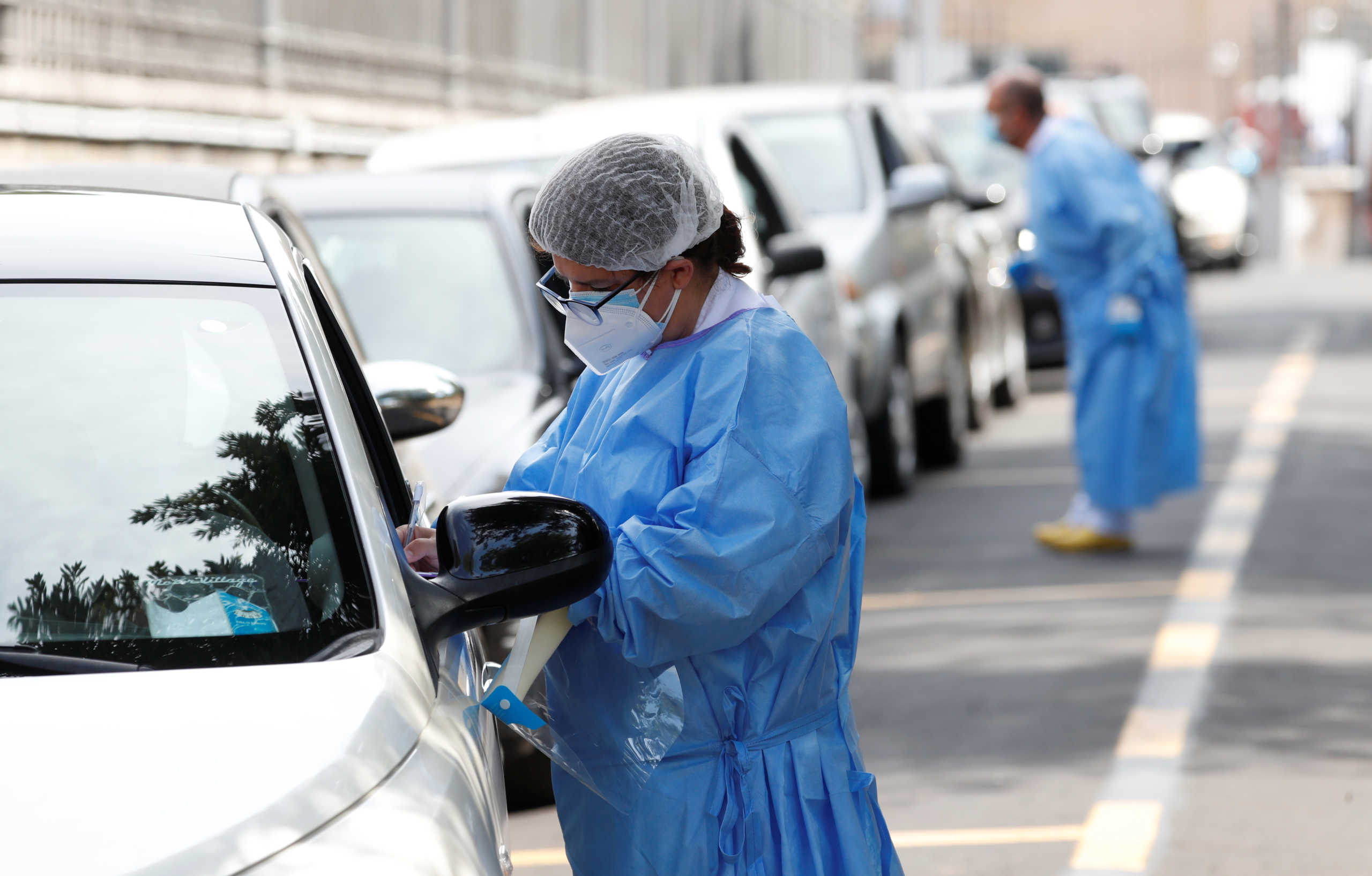 Healthcare workers register people at a coronavirus disease (COVID-19) drive in test centre at Rome's San Giovanni hospital in Rome, Italy, August 18, 2020. REUTERS