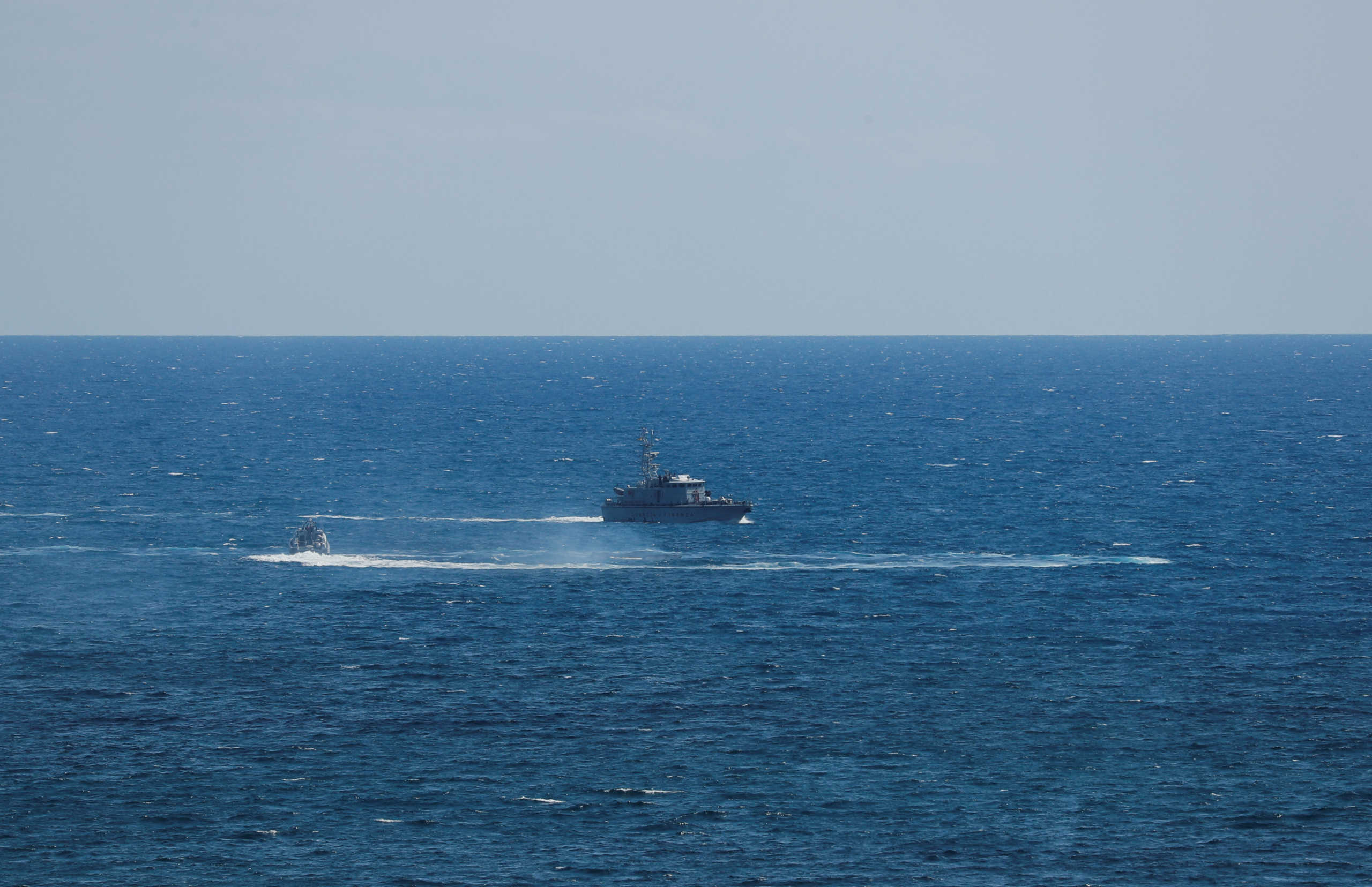 Guardia di Finanza boat is seen after a migrant boat caught fire during rescue operations off the coast of Crotone, with some people still missing according to Italian media, Italy August 30, 2020. REUTERS