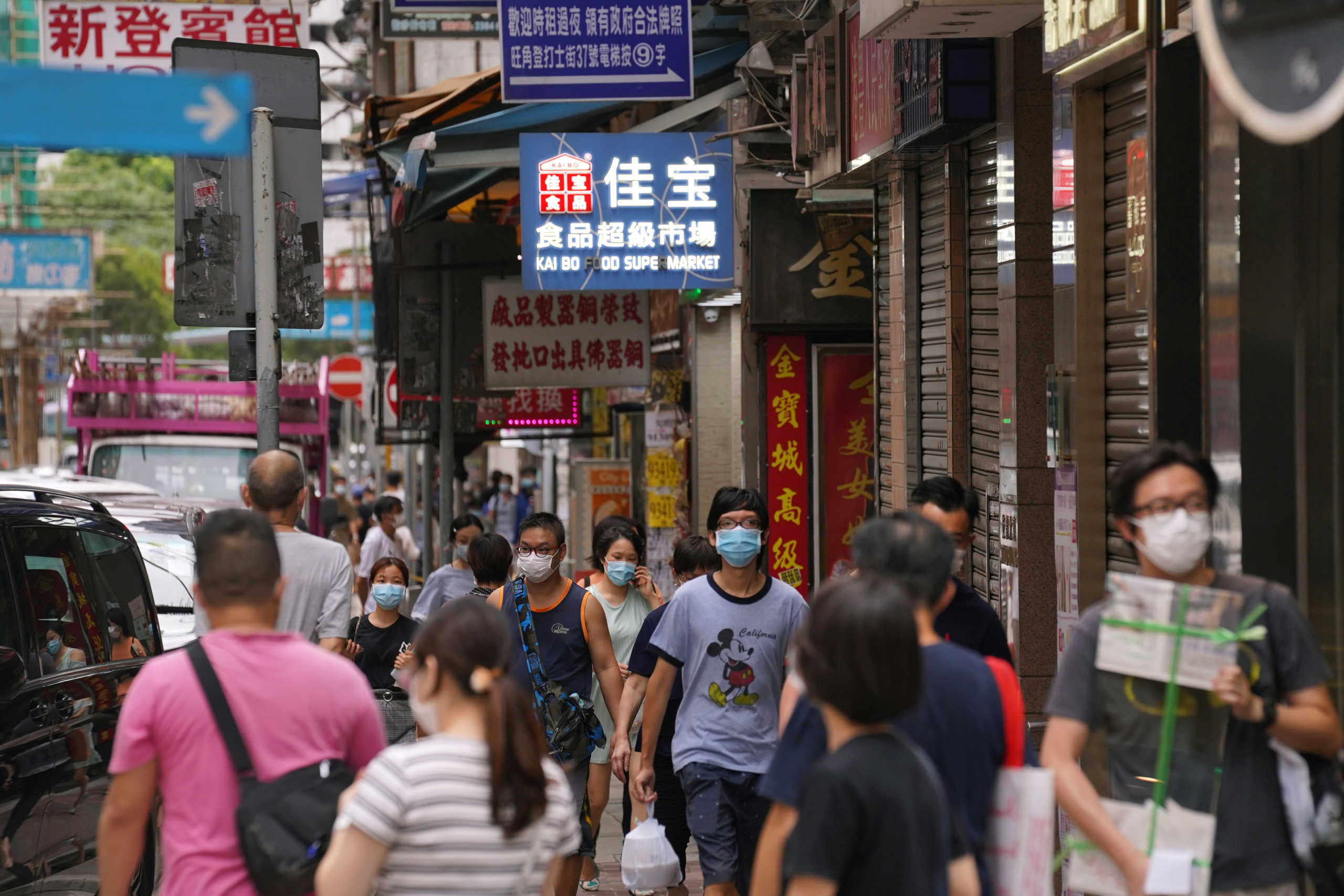 People wearing face masks walk on a street following the coronavirus disease (COVID-19) outbreak, in Hong Kong, China August 11, 2020. REUTERS