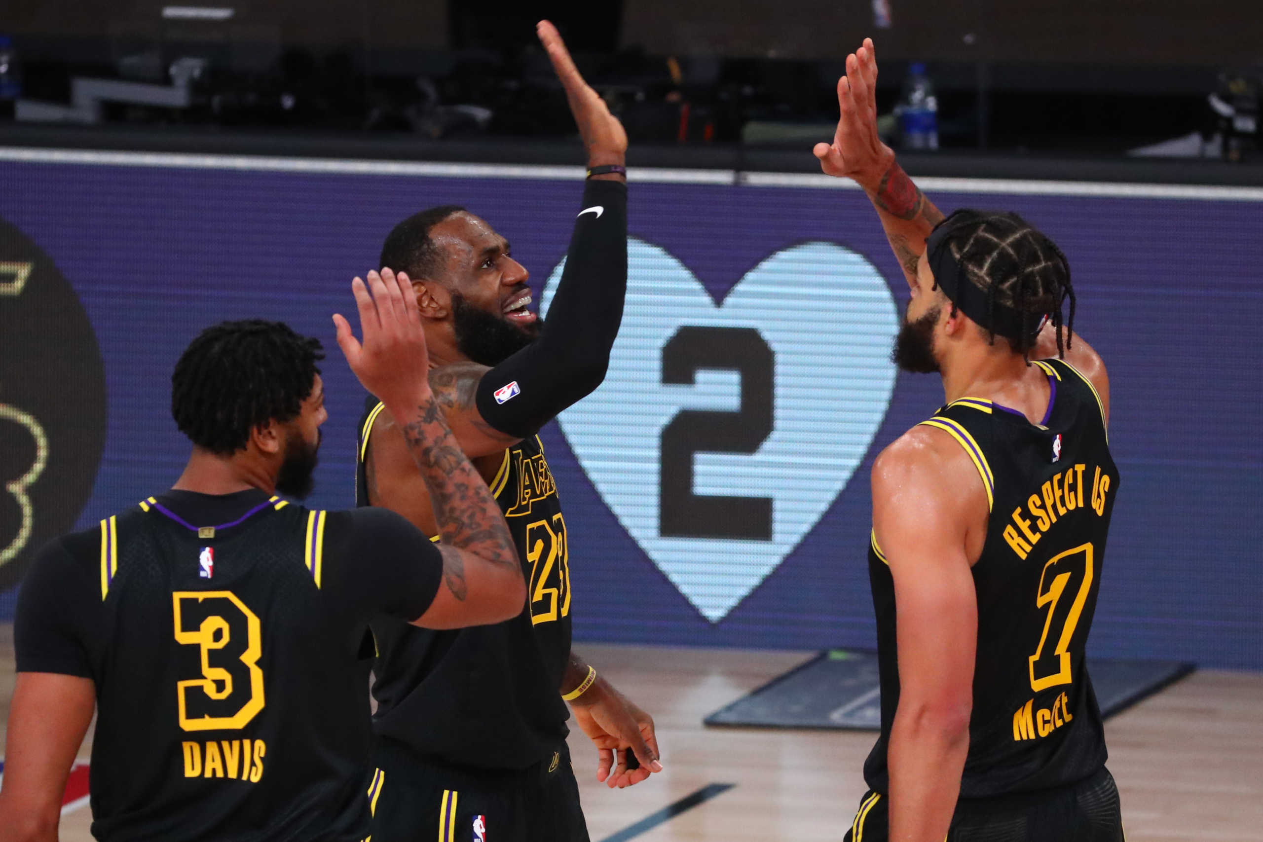 Aug 24, 2020; Lake Buena Vista, Florida, USA; Los Angeles Lakers forward LeBron James (23) celebrates after scoring a three pointer with center JaVale McGee (7) and forward Anthony Davis (3) in the first half against the Portland Trail Blazers in game four of the first round of the 2020 NBA Playoffs at AdventHealth Arena. Mandatory Credit: Kim Klement-USA TODAY Sports