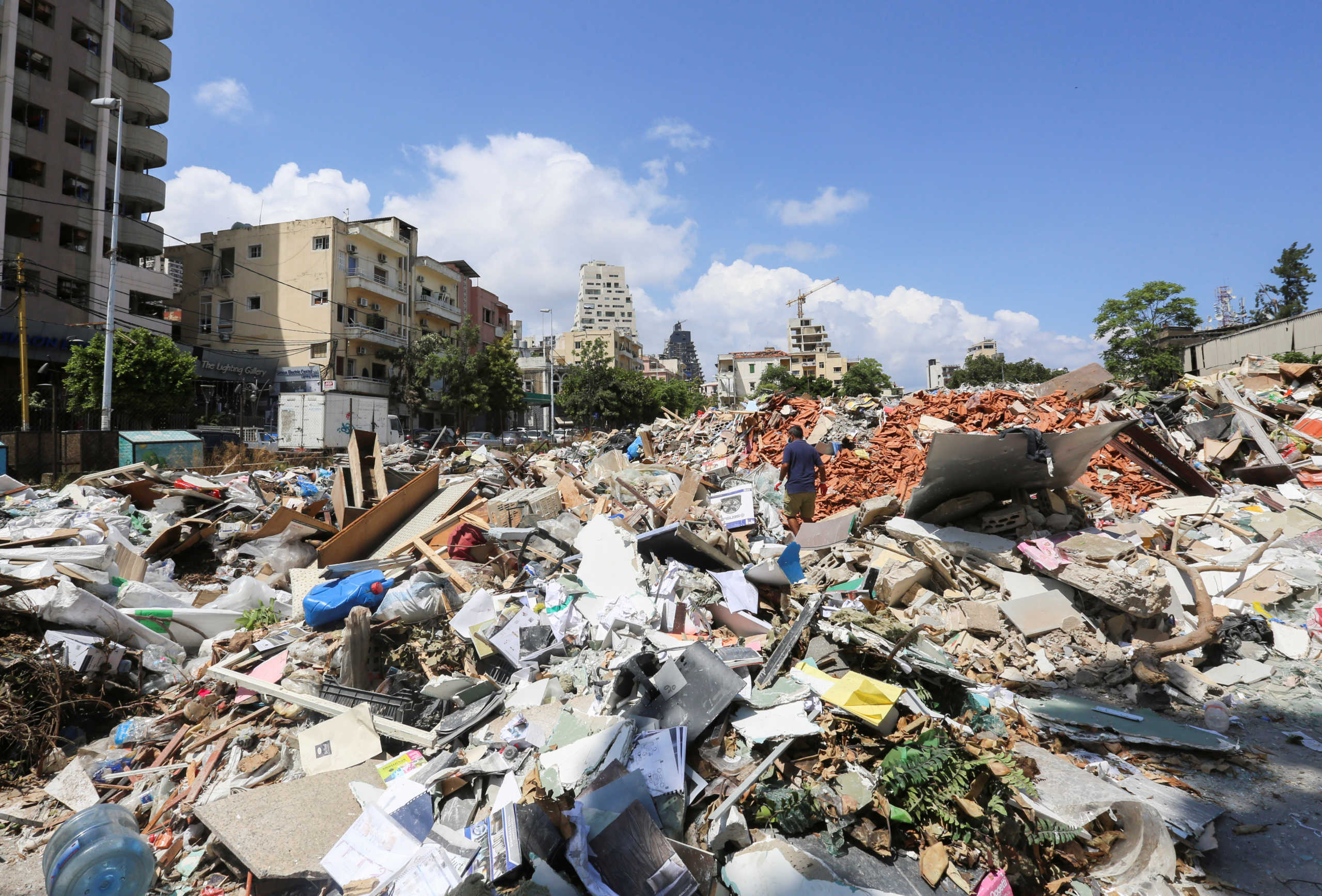 A man walks on the rubble of damaged buildings in the aftermath of a massive explosion in Beirut, Lebanon August 11, 2020. REUTERS