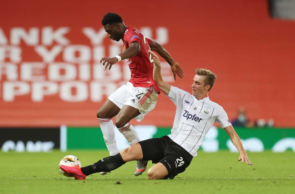 Soccer Football - Europa League - Round of 16 Second Leg - Manchester United v LASK Linz - Old Trafford, Manchester, Britain - August 5, 2020 Manchester United's Timothy Fosu-Mensah in action with LASK Linz's Marko Raguz, as play resumes behind closed doors following the outbreak of the coronavirus disease (COVID-19) REUTERS