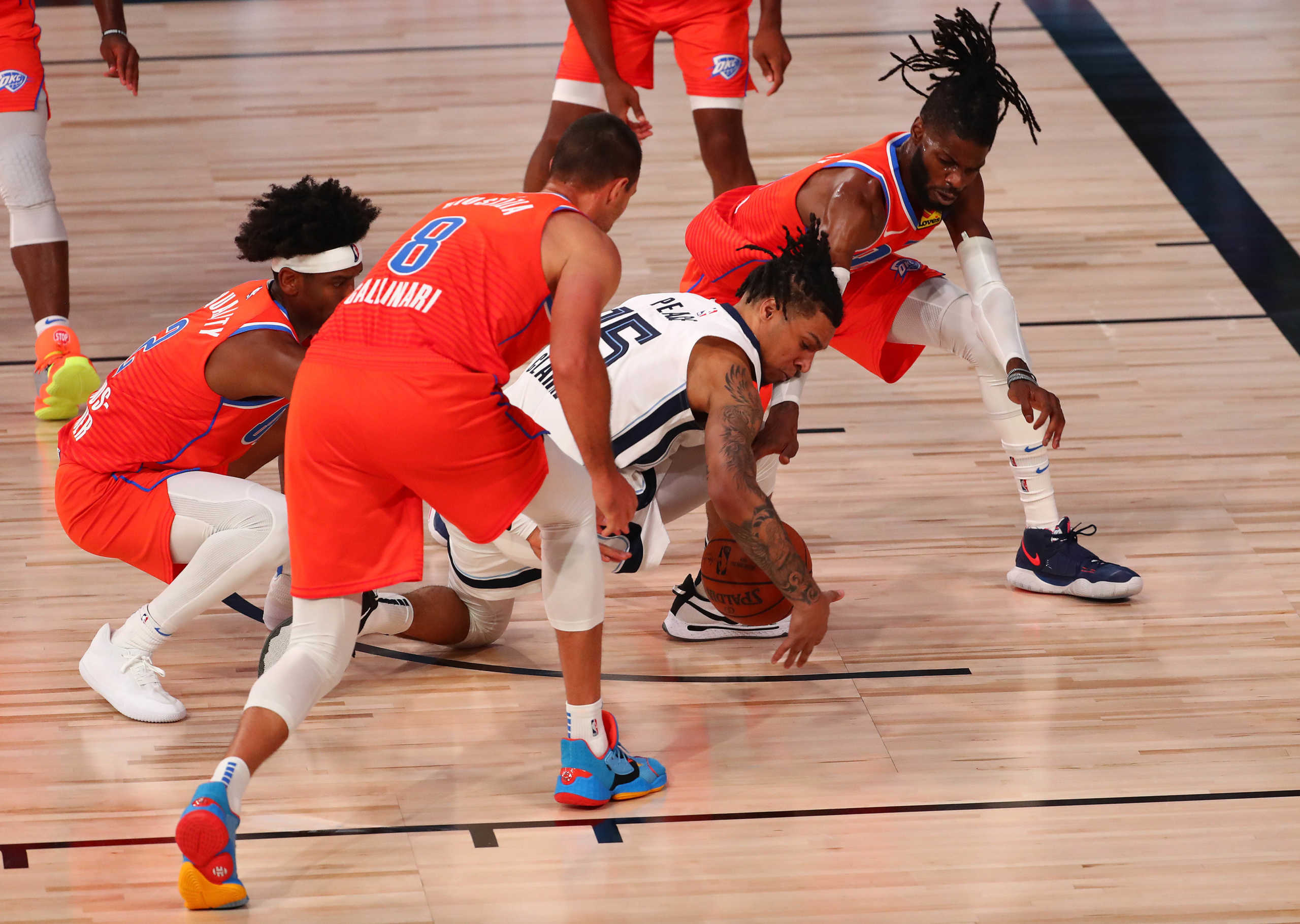 August 7, 2020; Lake Buena Vista, Florida, USA; Memphis Grizzlies forward Brandon Clarke (15) plays for the ball against Oklahoma City Thunder center Nerlens Noel (9) guard Shai Gilgeous-Alexander (2) and forward Danilo Gallinari (8) during the second half of an NBA game at Visa Athletic Center. Mandatory Credit: Kim Klement-USA TODAY Sports