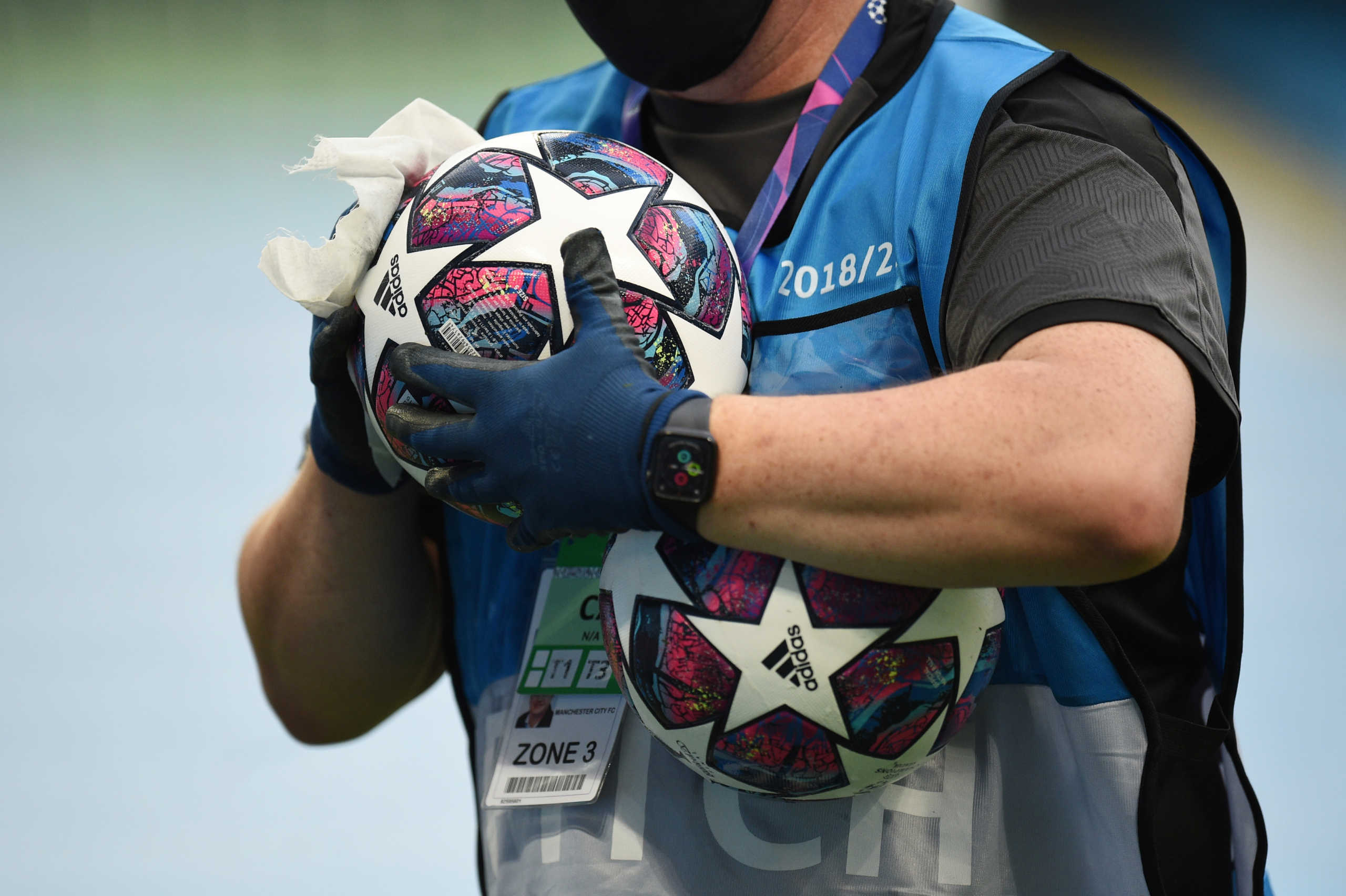 Soccer Football - Champions League - Round of 16 Second Leg - Manchester City v Real Madrid - Etihad Stadium, Manchester, Britain - August 7, 2020 A member of staff disinfects a football during the warm up before the match, as play resumes behind closed doors following the outbreak of the coronavirus disease (COVID-19) Pool via REUTERS