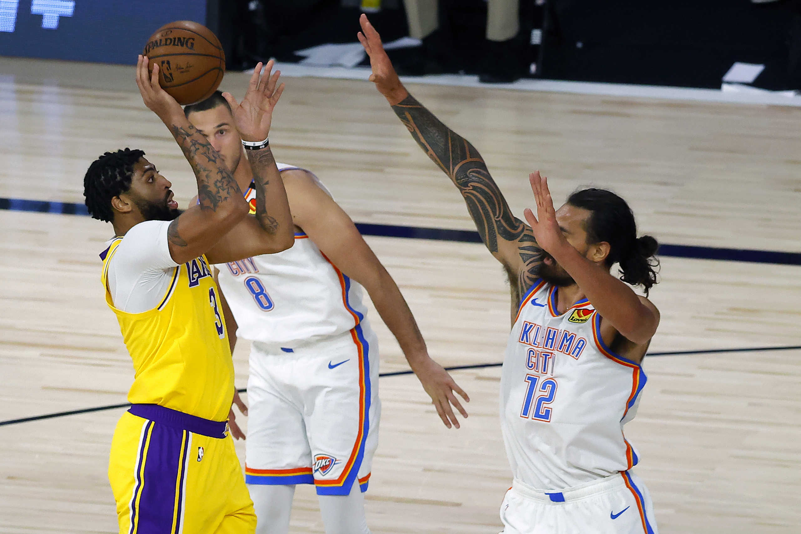 Aug 5, 2020; Lake Buena Vista, Florida, USA;  Anthony Davis #3 of the Los Angeles Lakers attempts a shot against Steven Adams #12 of the Oklahoma City Thunder during the third quarter at HP Field House at ESPN Wide World Of Sports Complex on August 05, 2020 in Lake Buena Vista, Florida.  Mandatory Credit: Kevin C. Cox