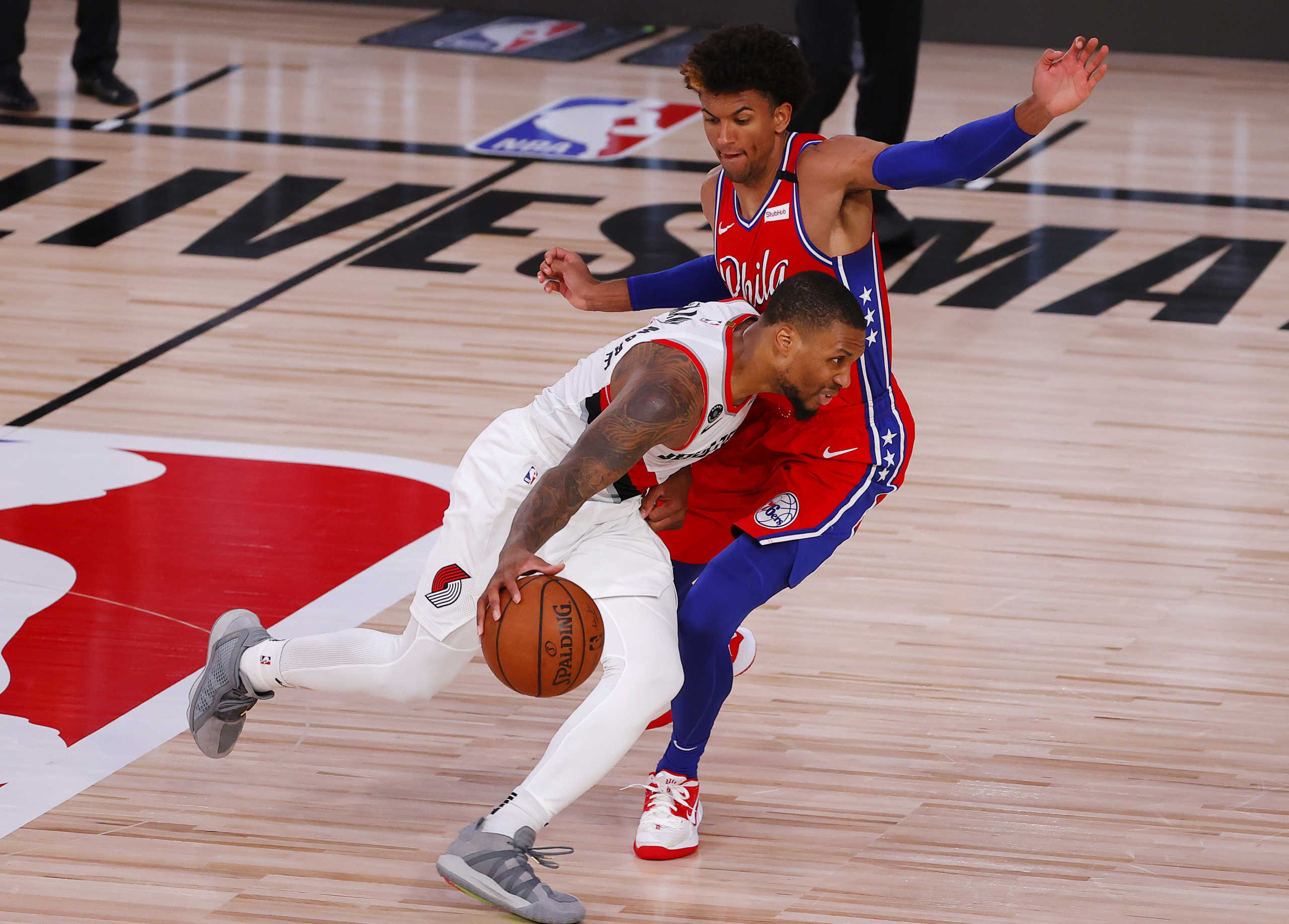 Aug 9, 2020; Lake Buena Vista, Florida, USA;  Damian Lillard #0 of the Portland Trail Blazers drives against Matisse Thybulle #22 of the Philadelphia 76ers during the fourth quarter at Visa Athletic Center at ESPN Wide World Of Sports Complex on August 09, 2020 in Lake Buena Vista, Florida.  Mandatory Credit: Kevin C. Cox