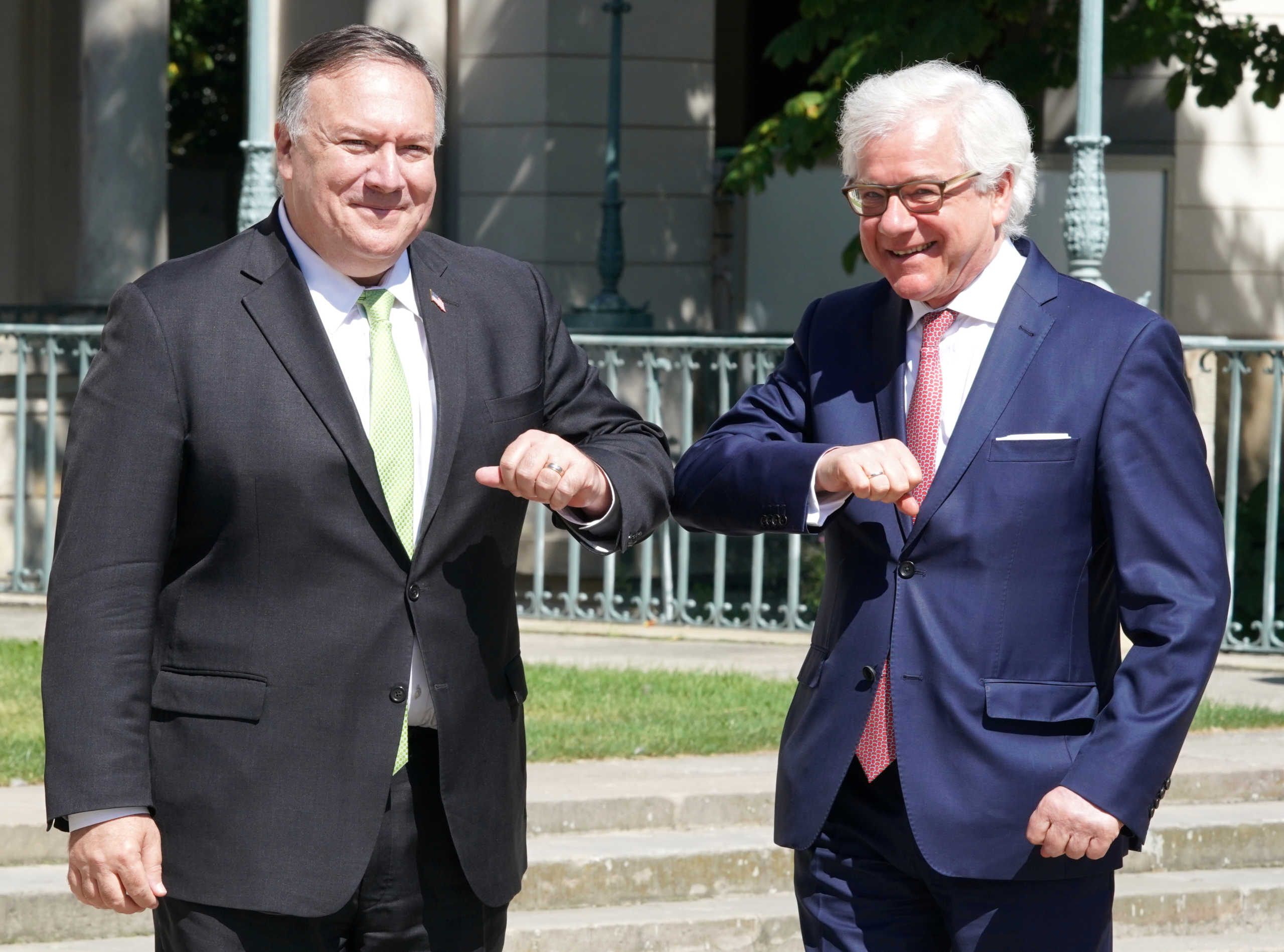 U.S. Secretary of State Mike Pompeo and Polish Foreign Minister Jacek Czaputowicz greet each other with an elbow bump in Lazienki Palace in Warsaw, Poland, August 15, 2020. Janek Skarzynski