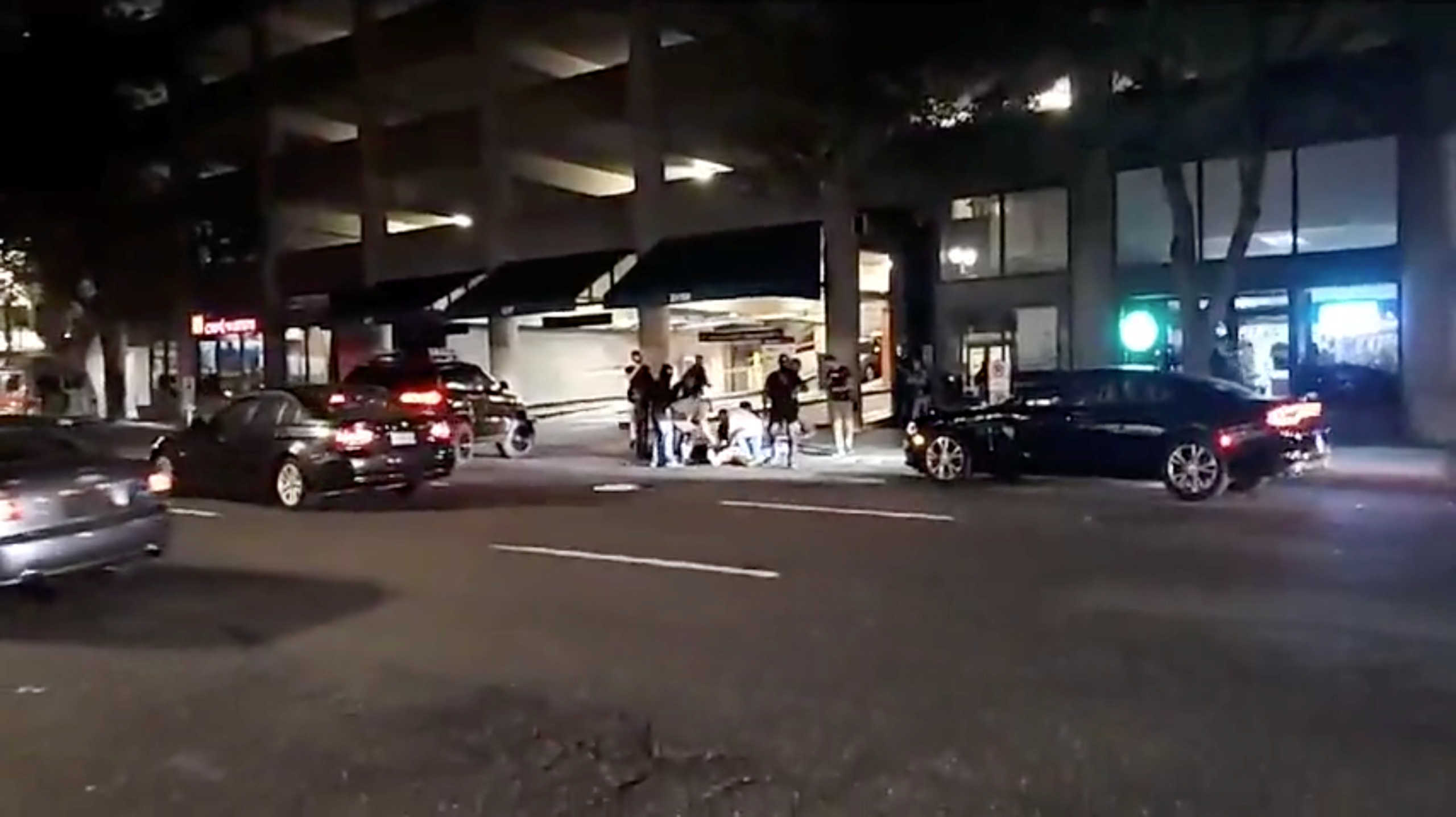 People surround a victim of a shooting in Portland, Oregon, U.S., August 29, 2020 in this screen grab obtained from a social media video. Justin Dunlap ? Democracy Field Trip
