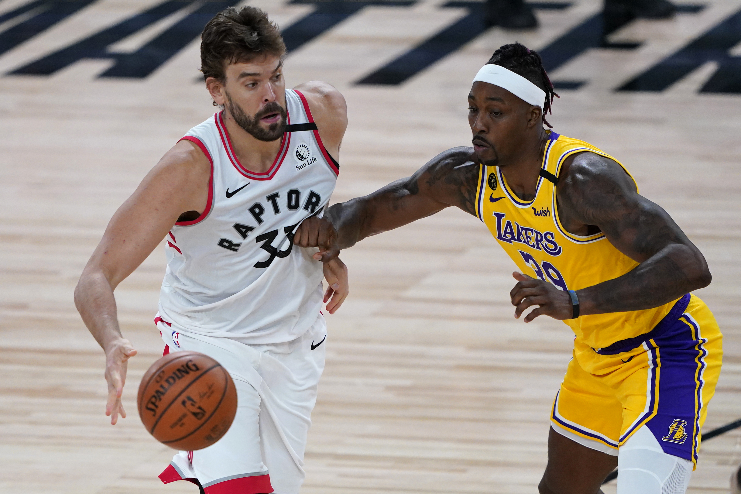 Aug 1, 2020; Lake Buena Vista, USA; Toronto Raptors center Marc Gasol (33) drives to the basket against Los Angeles Lakers center Dwight Howard (39) during the second half at The Arena. Mandatory Credit: Ashley Landis