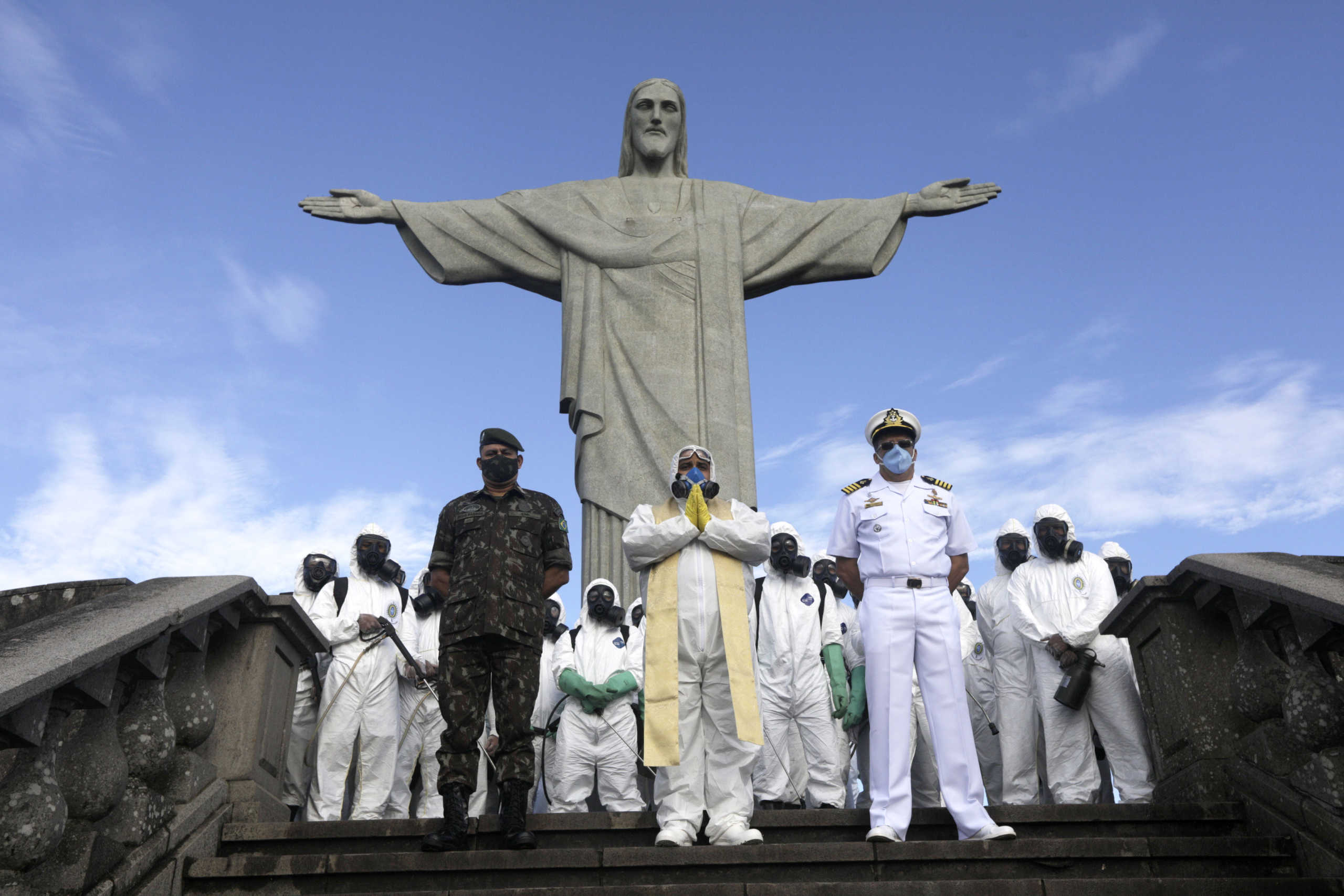 Catholic priest Omar is pictured with military members during disinfection works on Christ the Redeemer statue, ahead of its re-opening amid the coronavirus disease (COVID-19) outbreak, in Rio de Janeiro, Brazil, August 13, 2020. REUTERS