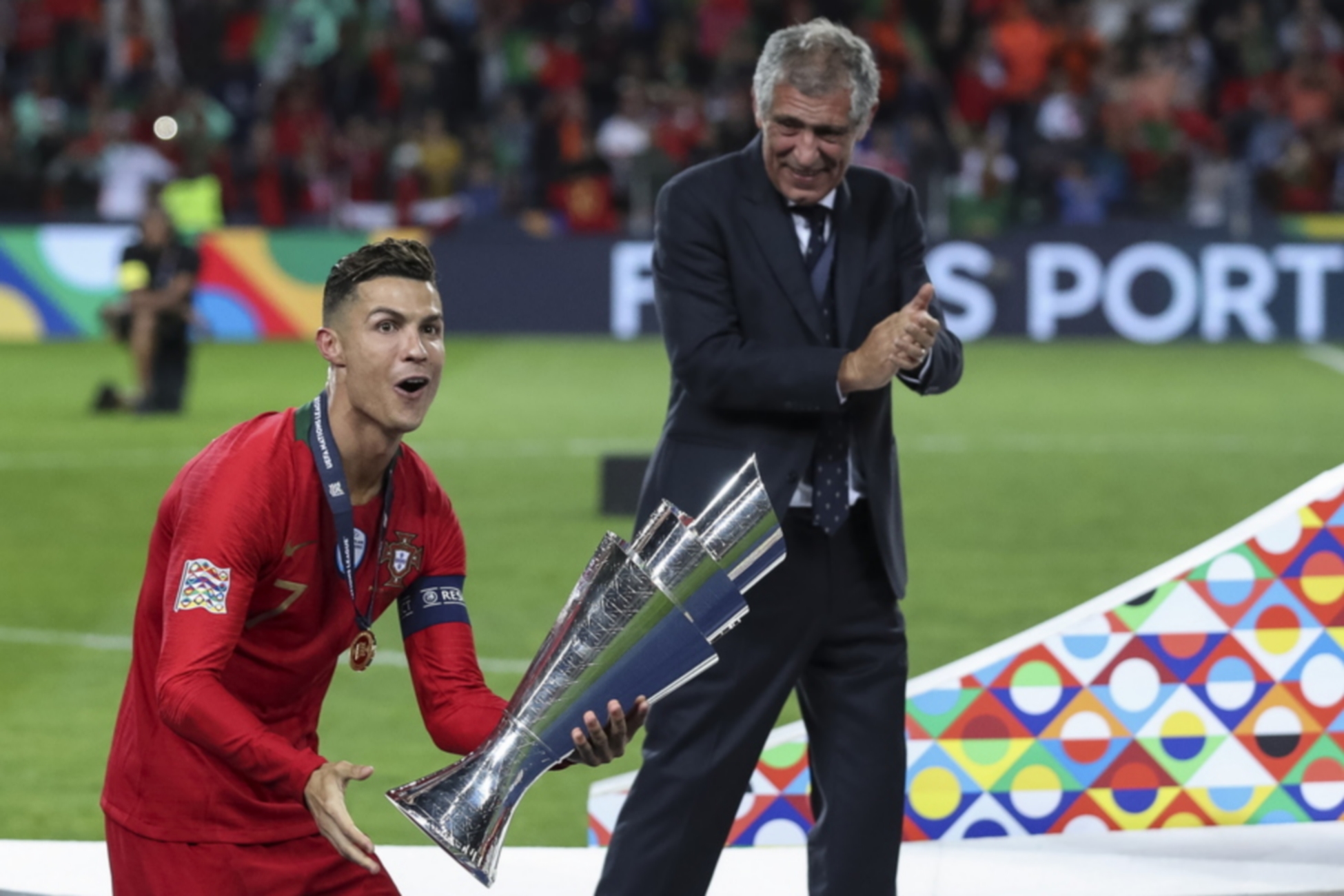 epa07637851 Portugal player Cristiano Ronaldo celebrates with the trophy next to Portuguese head coach Fernando Santos after winning the UEFA Nations League final soccer match Portugal vs Netherlands at Dragao stadium, Porto, Portugal, 09 June 2019.  EPA