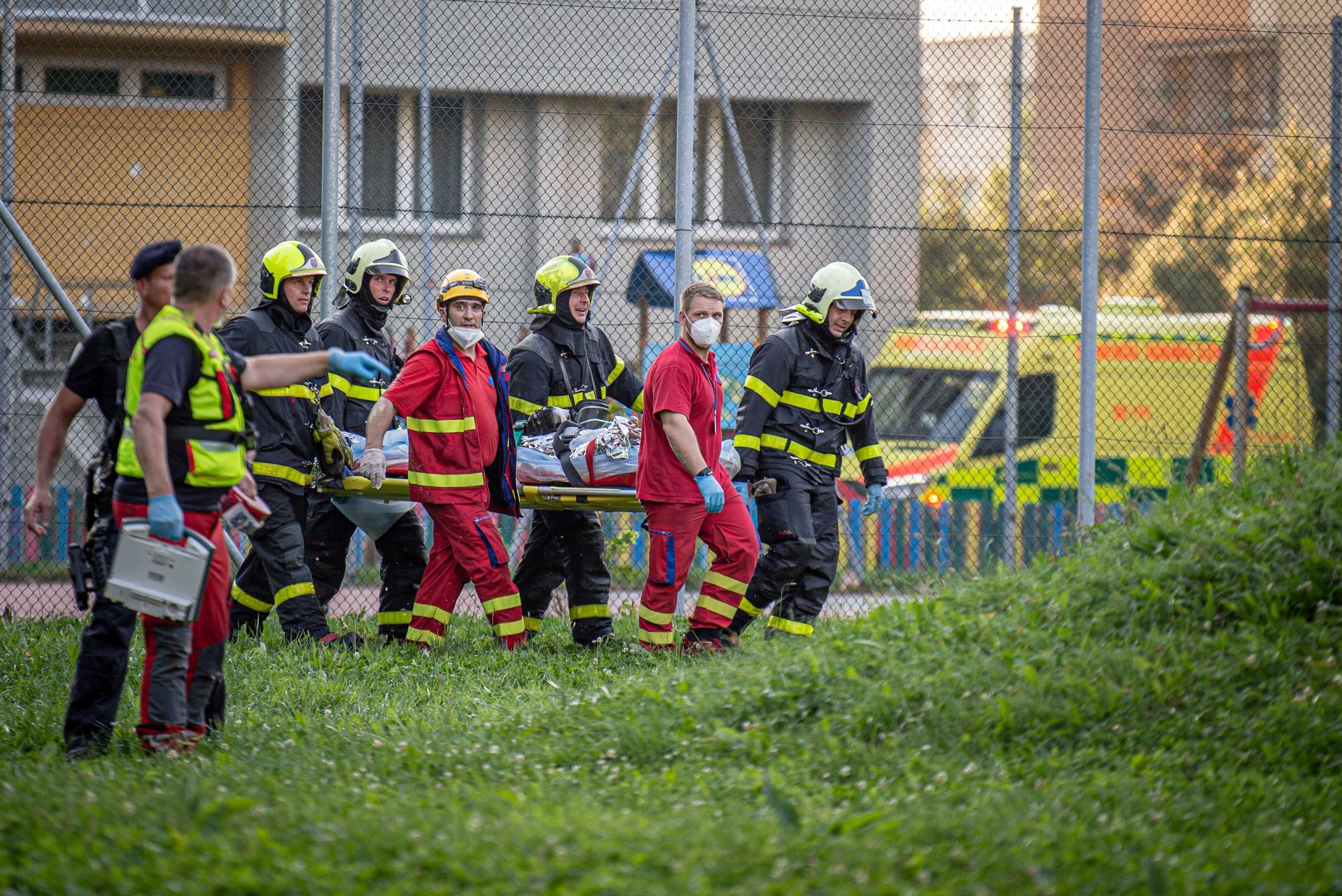 Firefighters carry a victim after a fire broke out in an apartment building in Bohumin, Czech Republic, August 8, 2020.   REUTERS