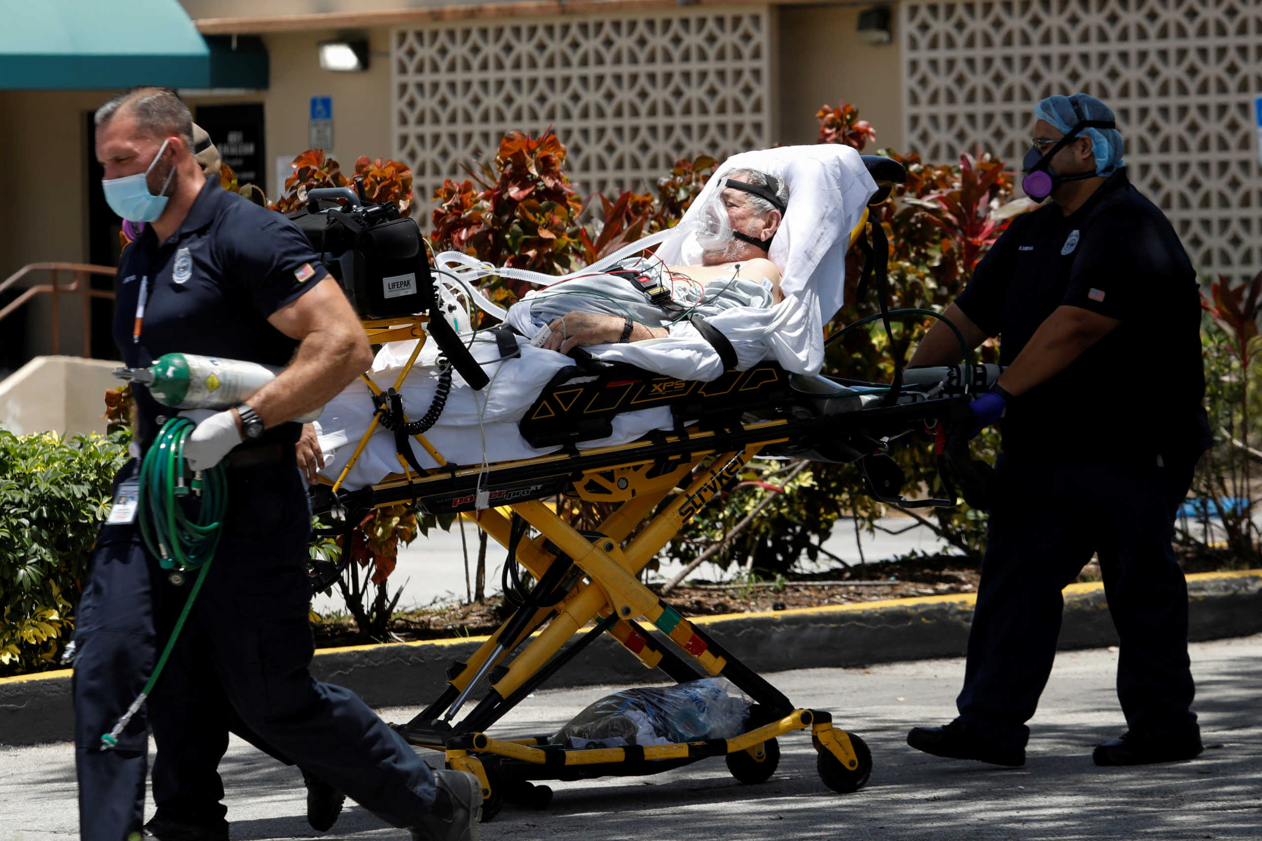 Emergency Medical Technicians (EMT) leave with a patient at Hialeah Hospital where the coronavirus disease (COVID-19) patients are treated, in Hialeah, Florida, U.S., July 29, 2020. REUTERS