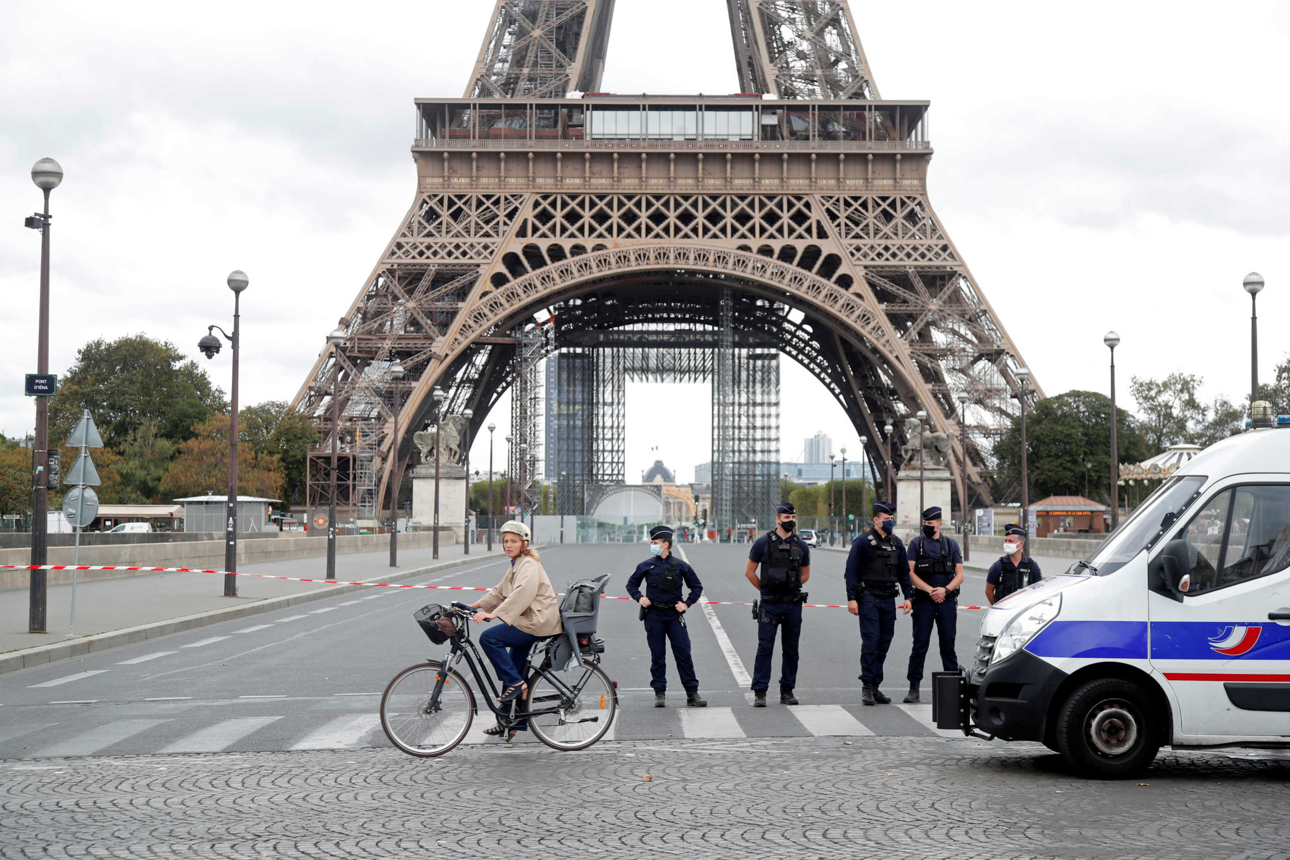 French police stand near the Eiffel Tower after the French tourism landmark was evacuated following a bomb alert in Paris, France, September 23, 2020. REUTERS