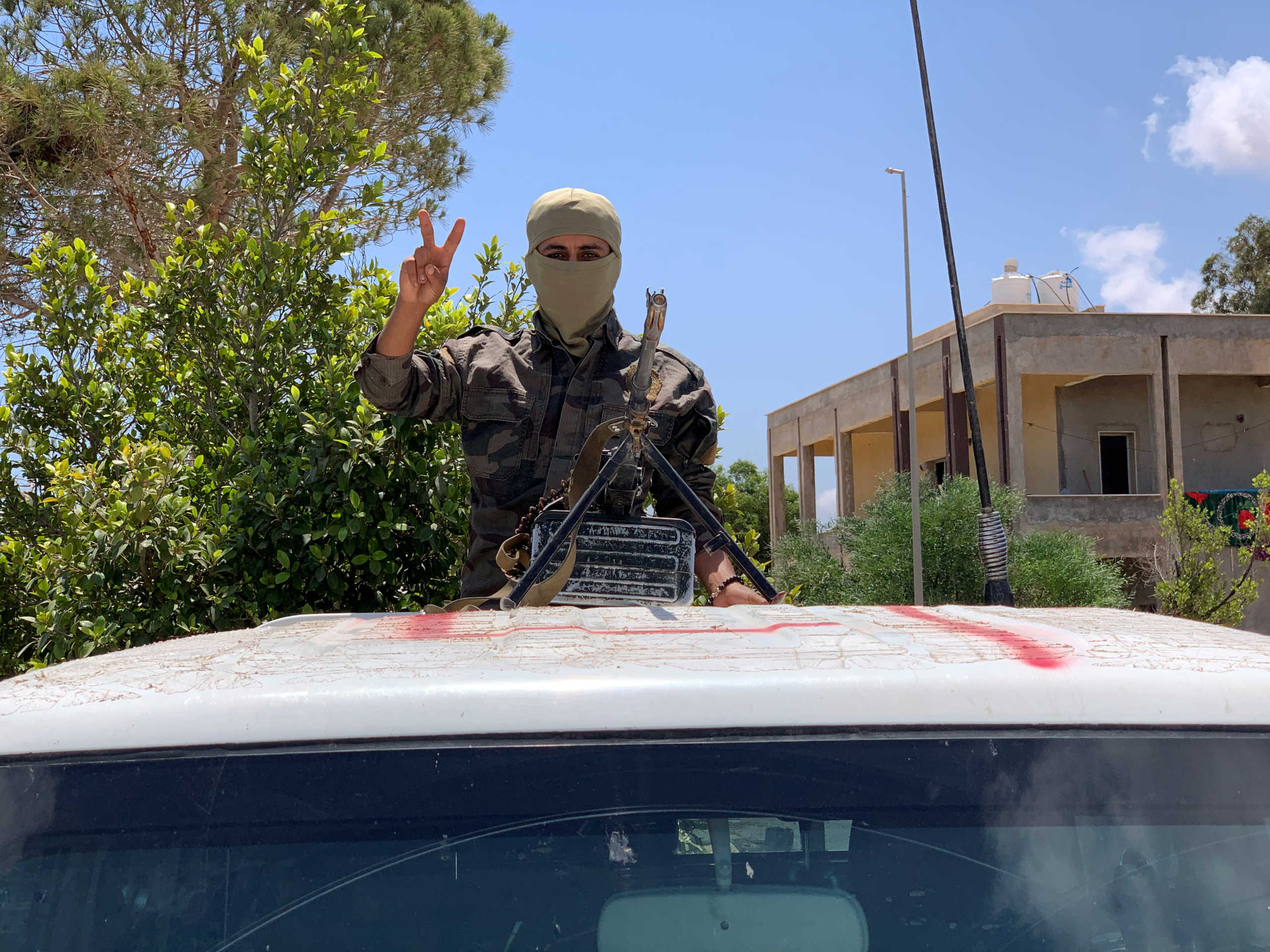 A member of the troops of loyal to Libya's internationally recognized government flashes a victory sign as he prepares himself before heading to Sirte, in Tripoli, Libya, Libya July 6, 2020. REUTERS
