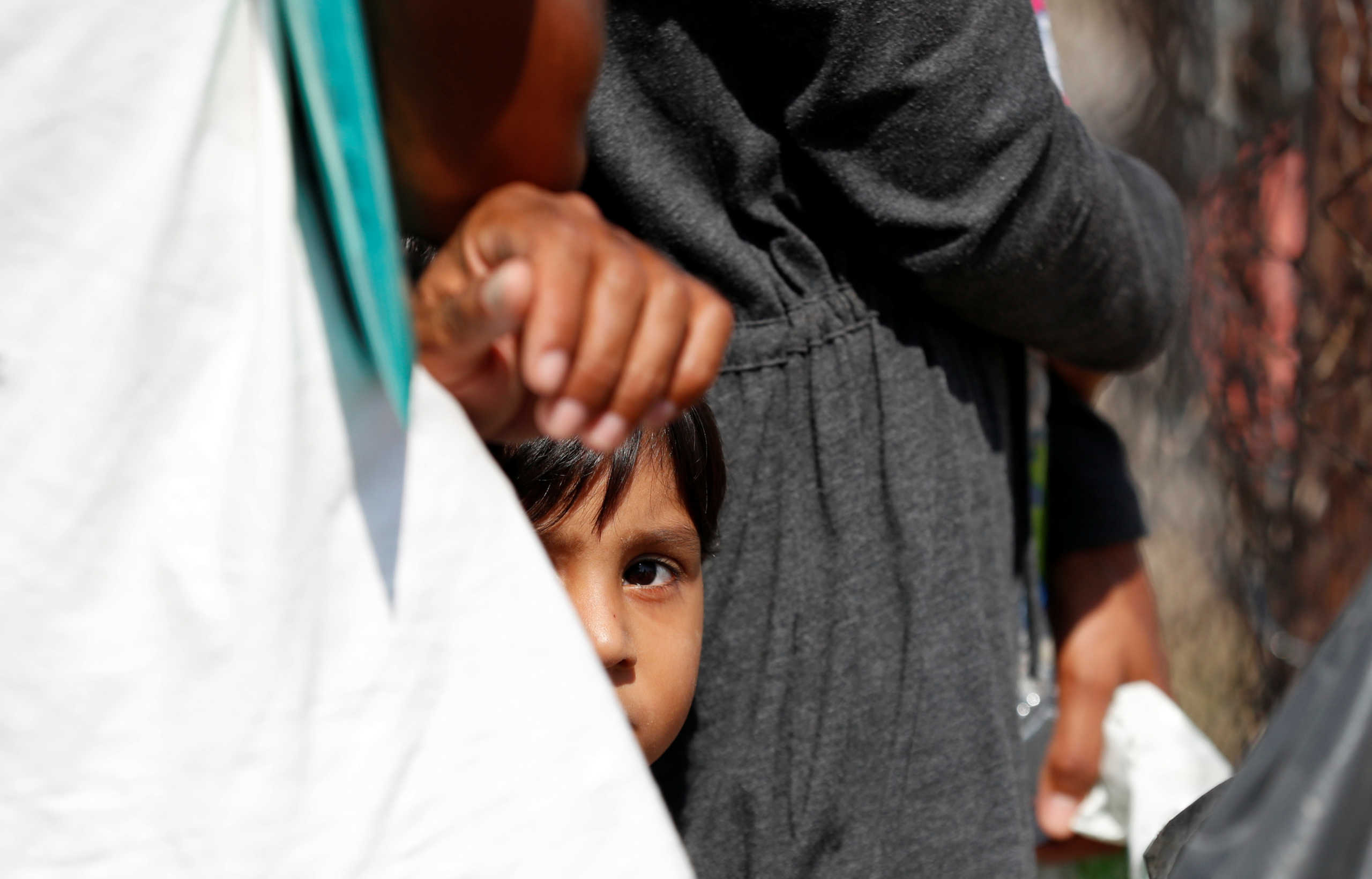 A child is seen outside the new temporary camp for migrants and refugees, on the island of Lesbos, Greece, September 23, 2020. REUTERS