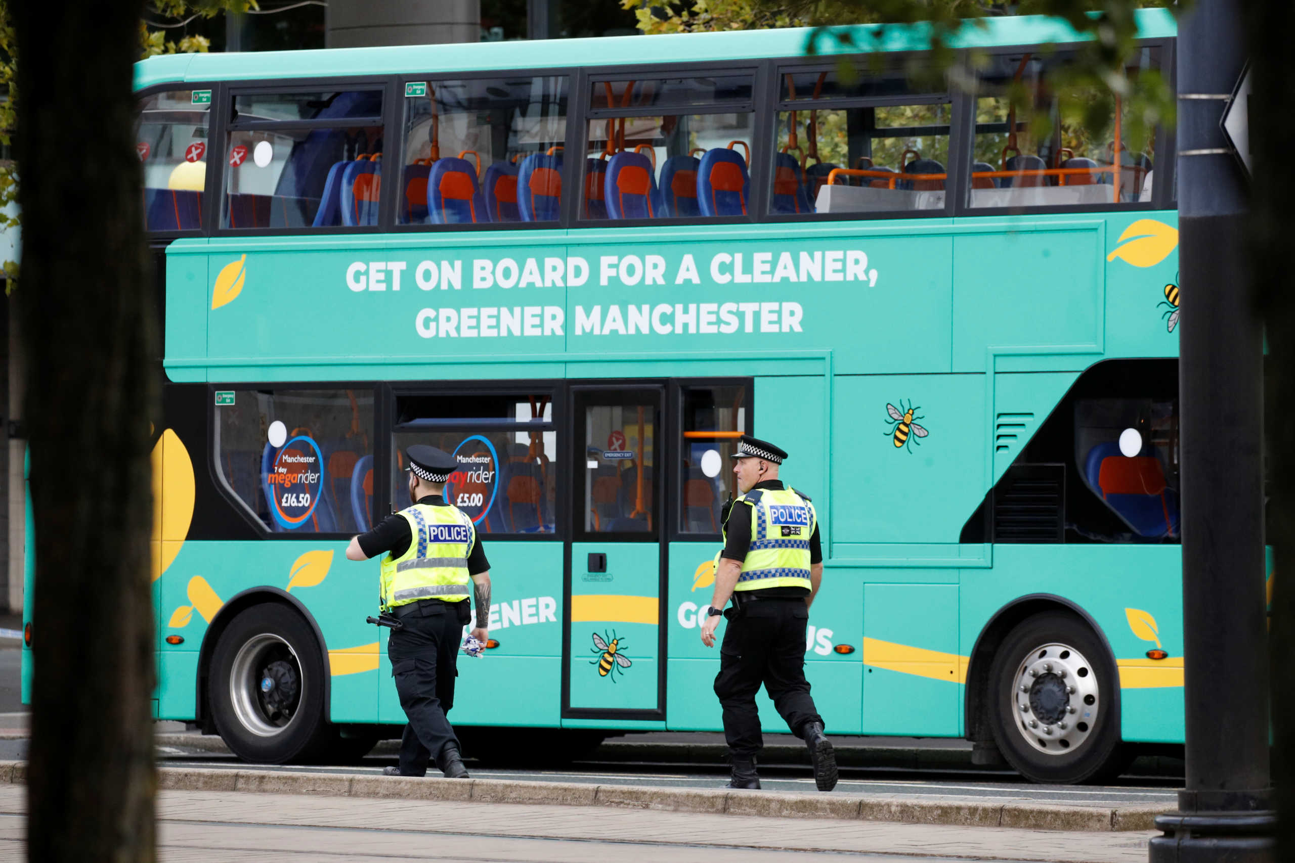 Police officers walk near the bus where a suspect package was found, in Manchester city centre, Britain September 5, 2020. REUTERS