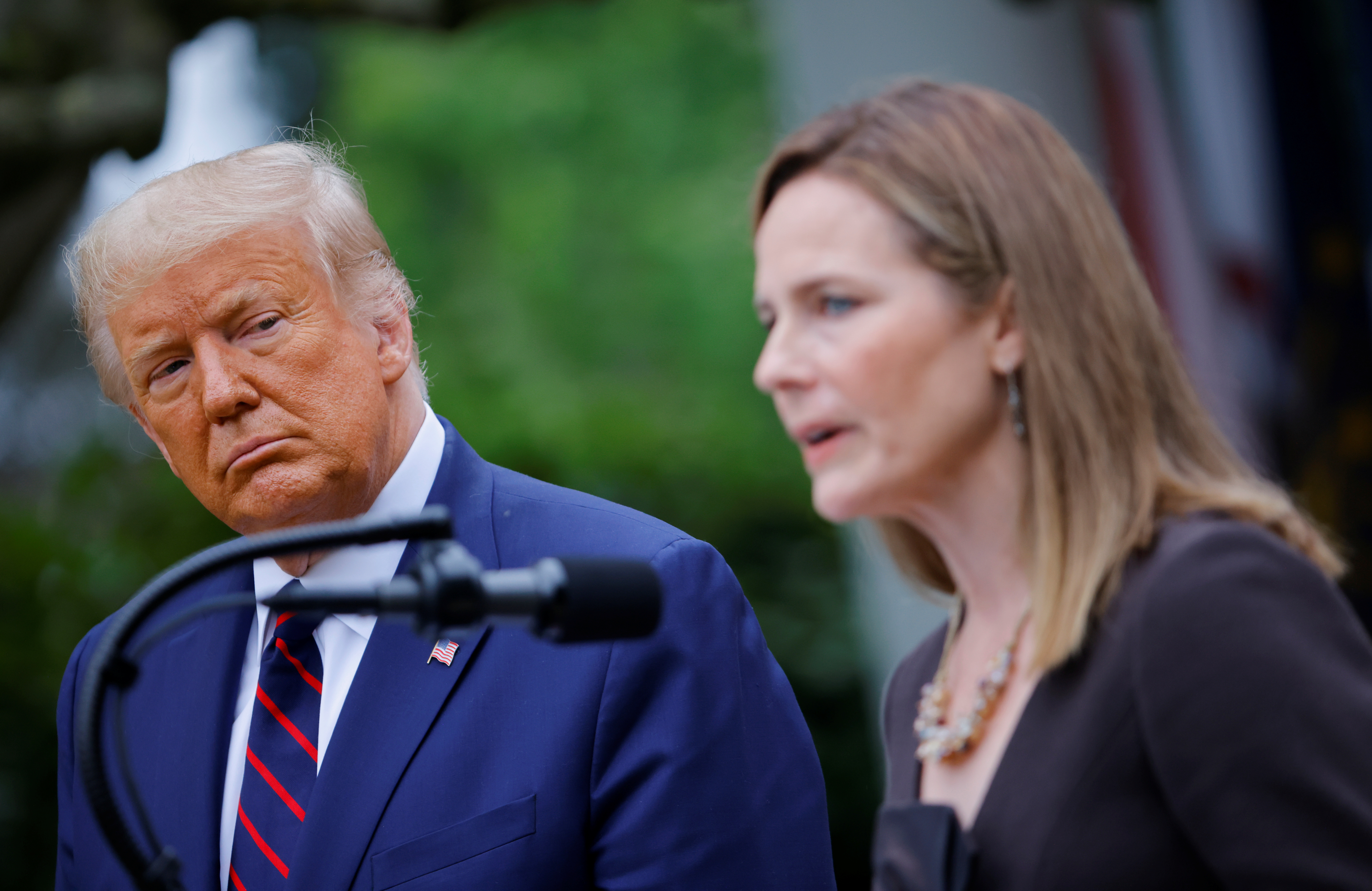 U.S President Donald Trump watches U.S. Court of Appeals for the Seventh Circuit Judge Amy Coney Barrett deliver remarks as he holds an event to announce her as his nominee to fill the Supreme Court seat left vacant by the death of Justice Ruth Bader Ginsburg, who died on September 18, at the White House in Washington, U.S., September 26, 2020. REUTERS