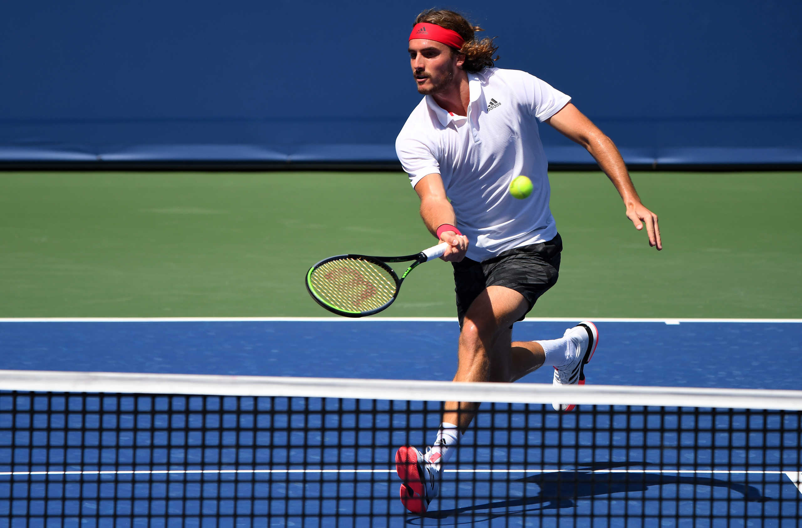 Aug 28, 2020; Flushing Meadows, New York, USA; Stefanos Tsitsipas (GRE) hits the ball against Milos Raonic (CAN) during the Western & Southern Open at the USTA Billie Jean King National Tennis Center. Mandatory Credit: Robert Deutsch-USA TODAY Sports