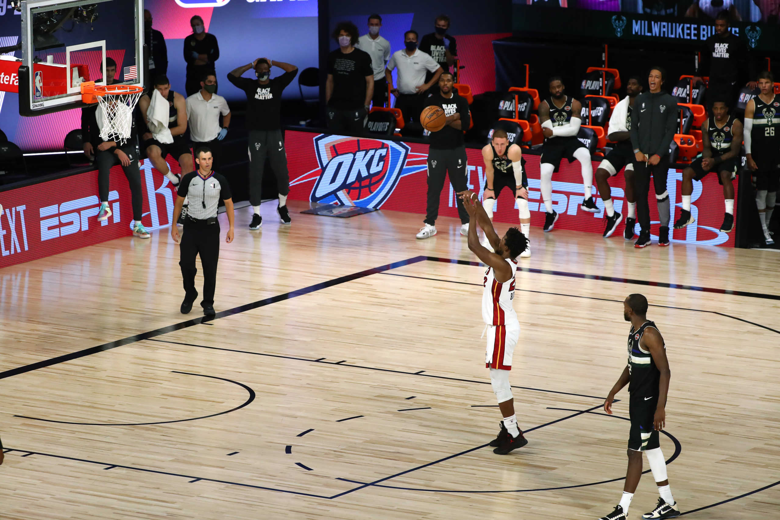 Sep 2, 2020; Lake Buena Vista, Florida, USA; Miami Heat forward Jimmy Butler (22) shoots a free throw in the last second of the game as Milwaukee Bucks forward Khris Middleton (22) looks on in game two of the second round of the 2020 Stanley Cup Playoffs at The Field House. Mandatory Credit: Kim Klement-USA TODAY Sports