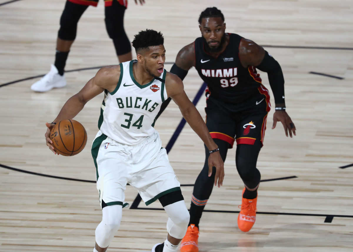 Aug 31, 2020; Lake Buena Vista, Florida, USA; Milwaukee Bucks forward Giannis Antetokounmpo (34) dribbles the ball against Miami Heat forward Jae Crowder (99) during the third quarter in game one of the second round of the 2020 NBA Playoffs at The Field House. Mandatory Credit: Kim Klement-USA TODAY Sports